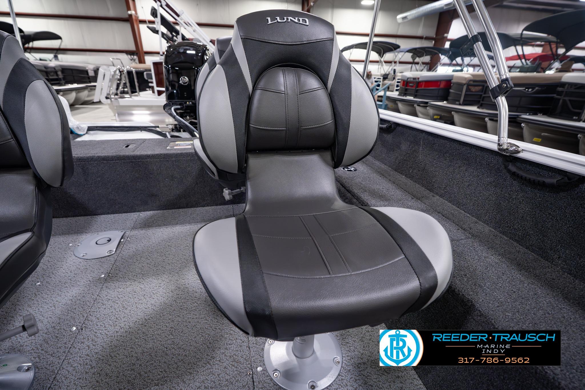 2026 Lund 1650 Rebel XL SS boat seat in showroom, featuring sleek black and gray design.