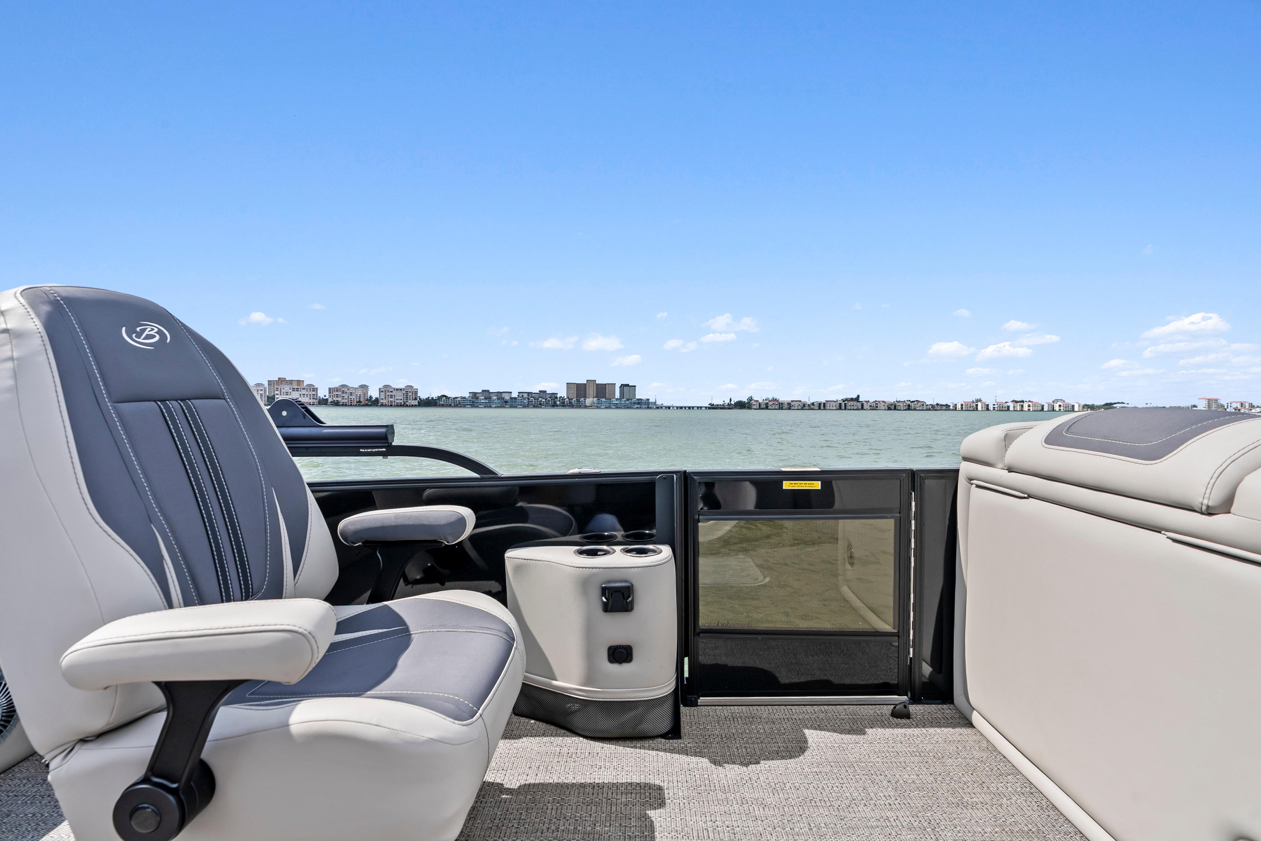 2025 Barletta Corsa 23UC pontoon boat interior with luxurious seating and scenic water view.