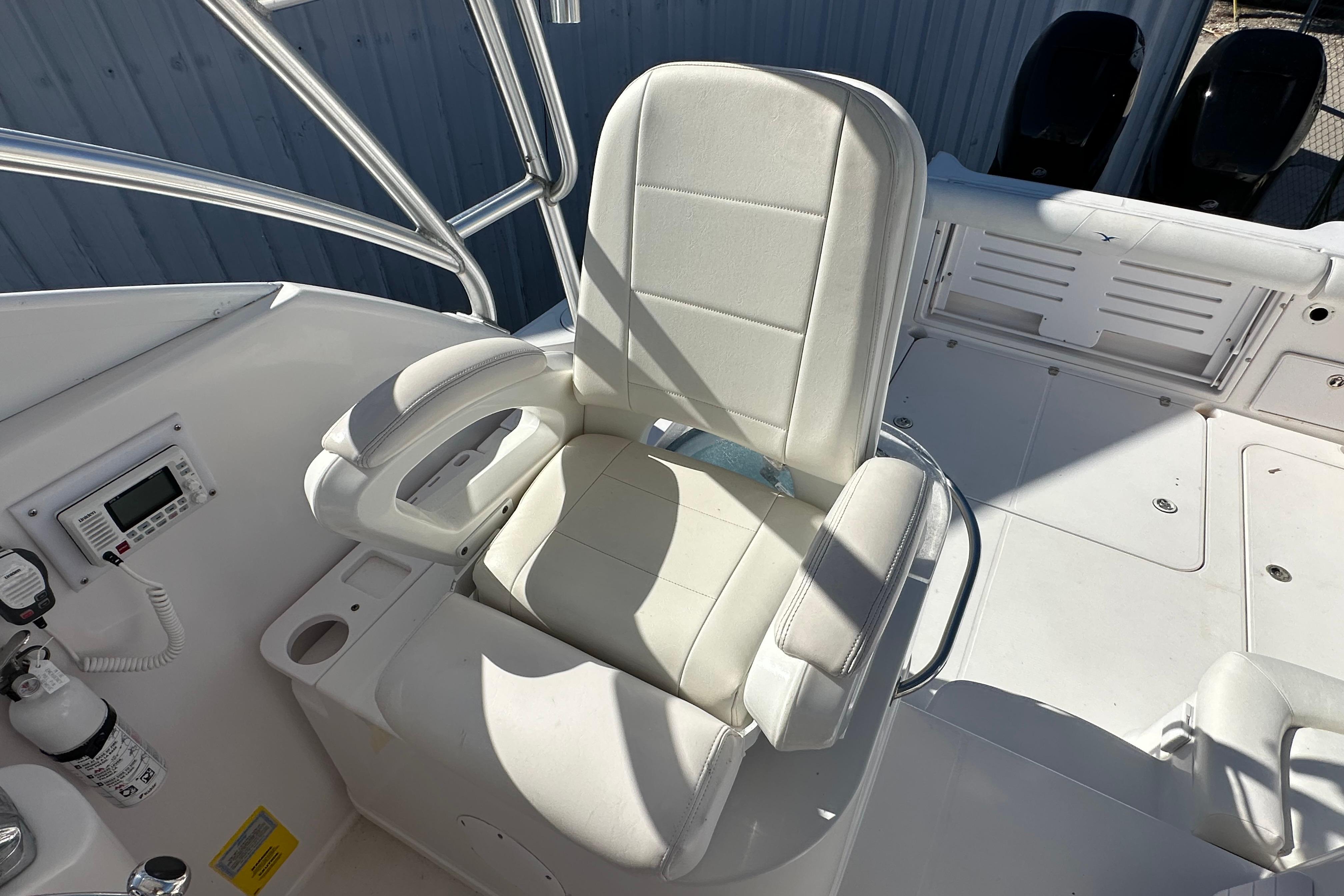 Captain's chair on 2006 Pro-Line 32 Express boat, featuring white upholstery and control panel.