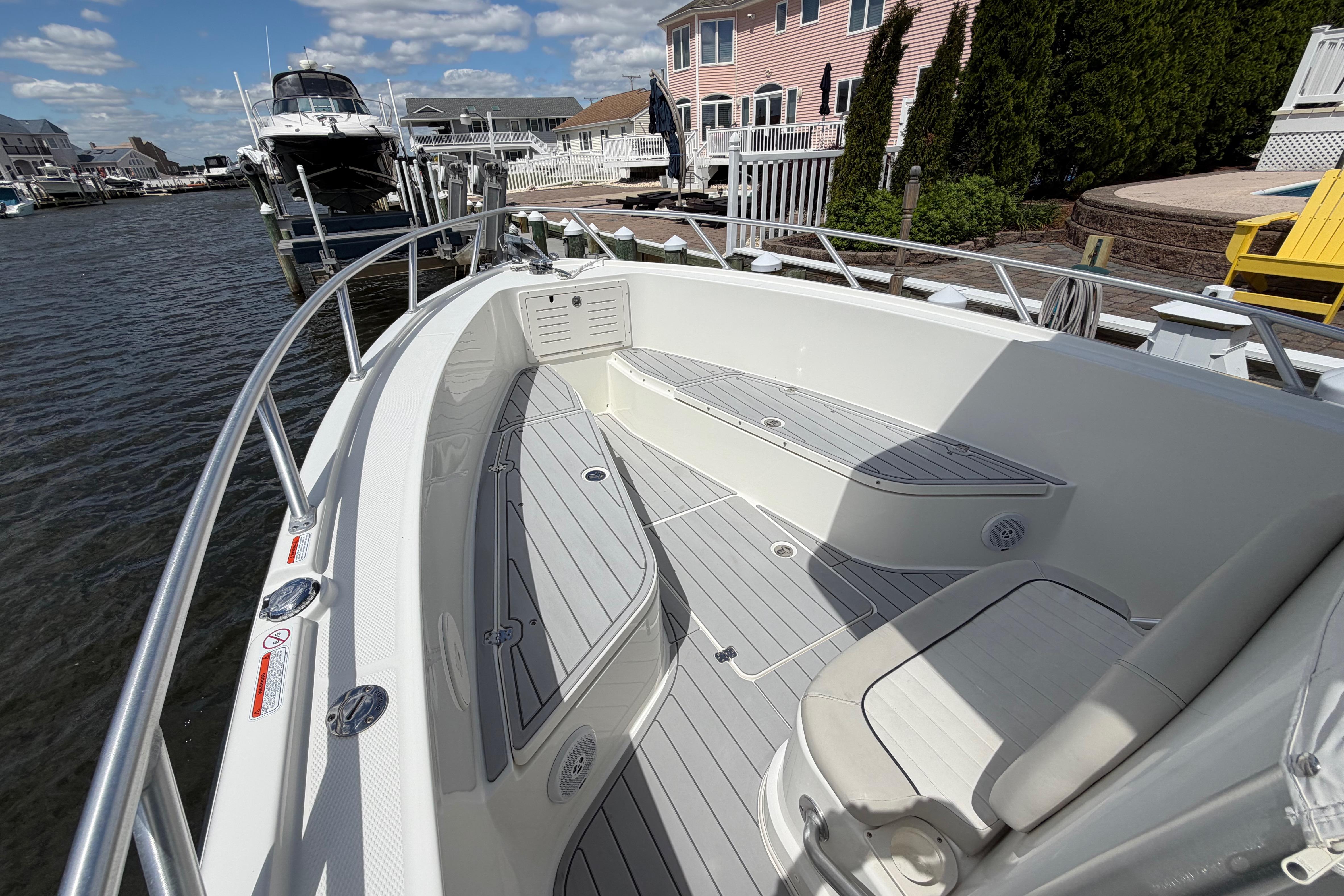 2017 Mako 284 Center Console boat docked, featuring spacious seating and sleek design.