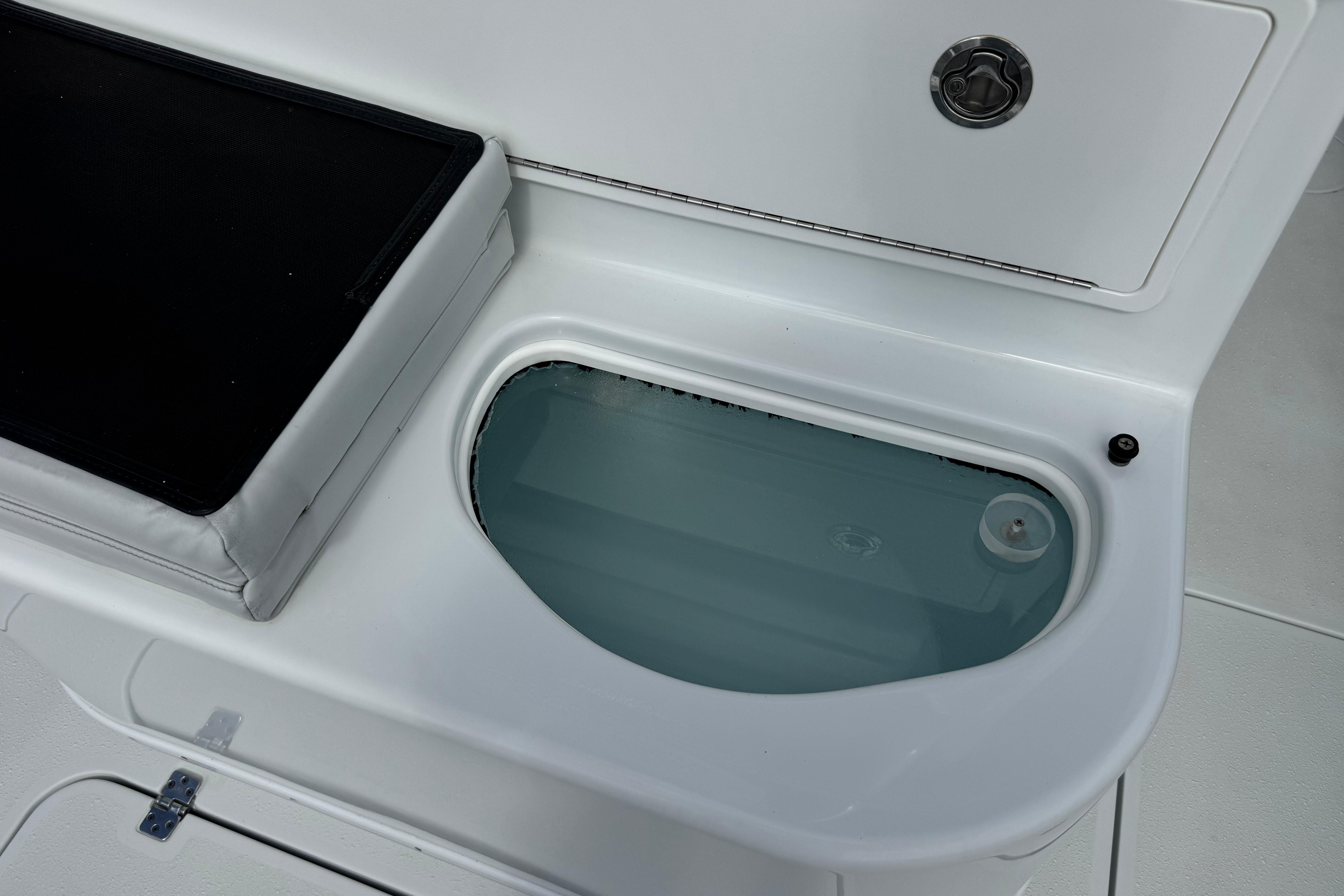Livewell on 2022 Yellowfin 32 Offshore boat, featuring sleek white design.