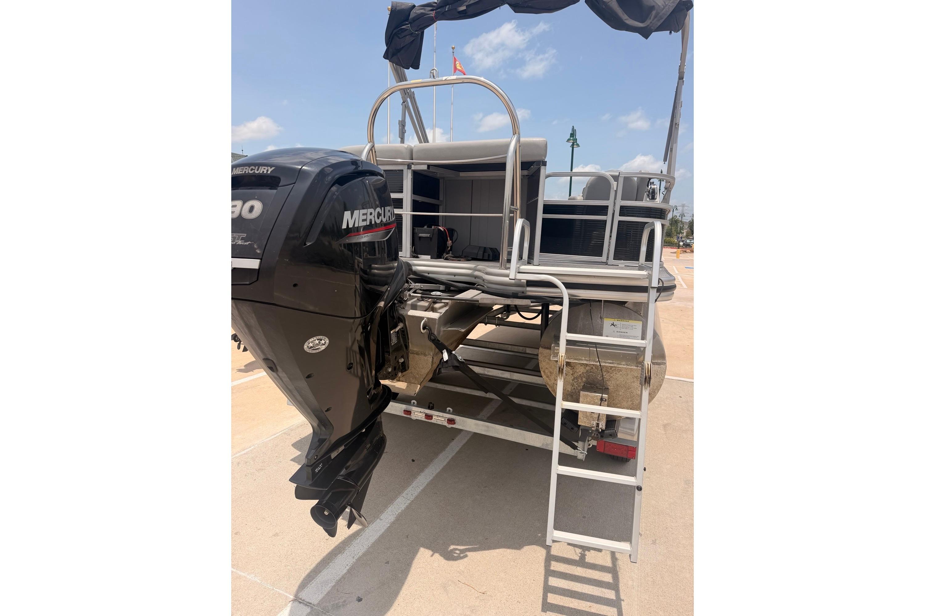 2021 Lowe SS 210 pontoon boat with Mercury outboard motor, docked under clear skies.