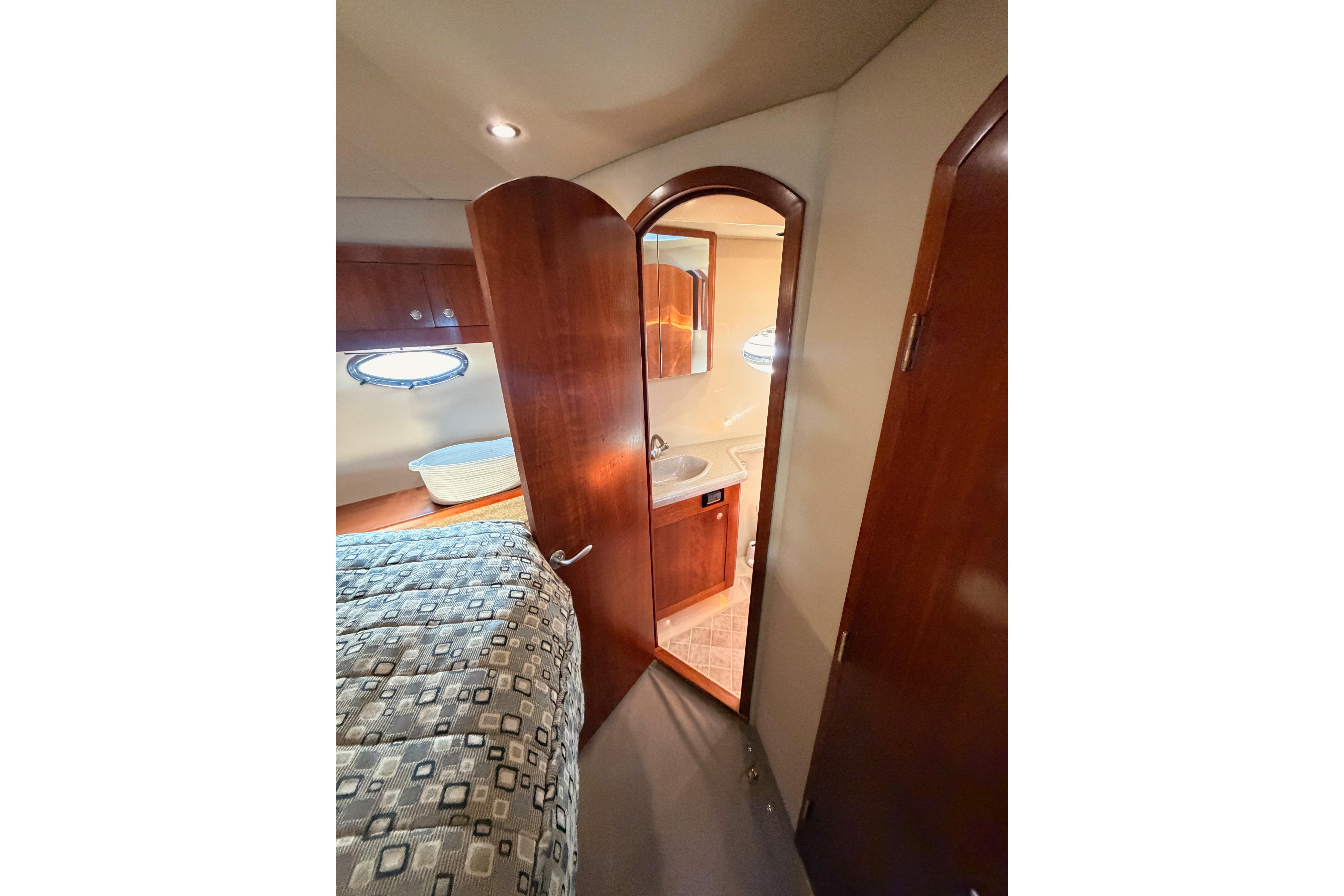 Interior of 2005 Cruisers Yachts 405 Express Motoryacht with bedroom and bathroom view.