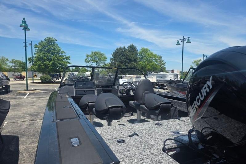 2026 Tracker Targa V-18 Combo boat with Mercury engine in parking lot.