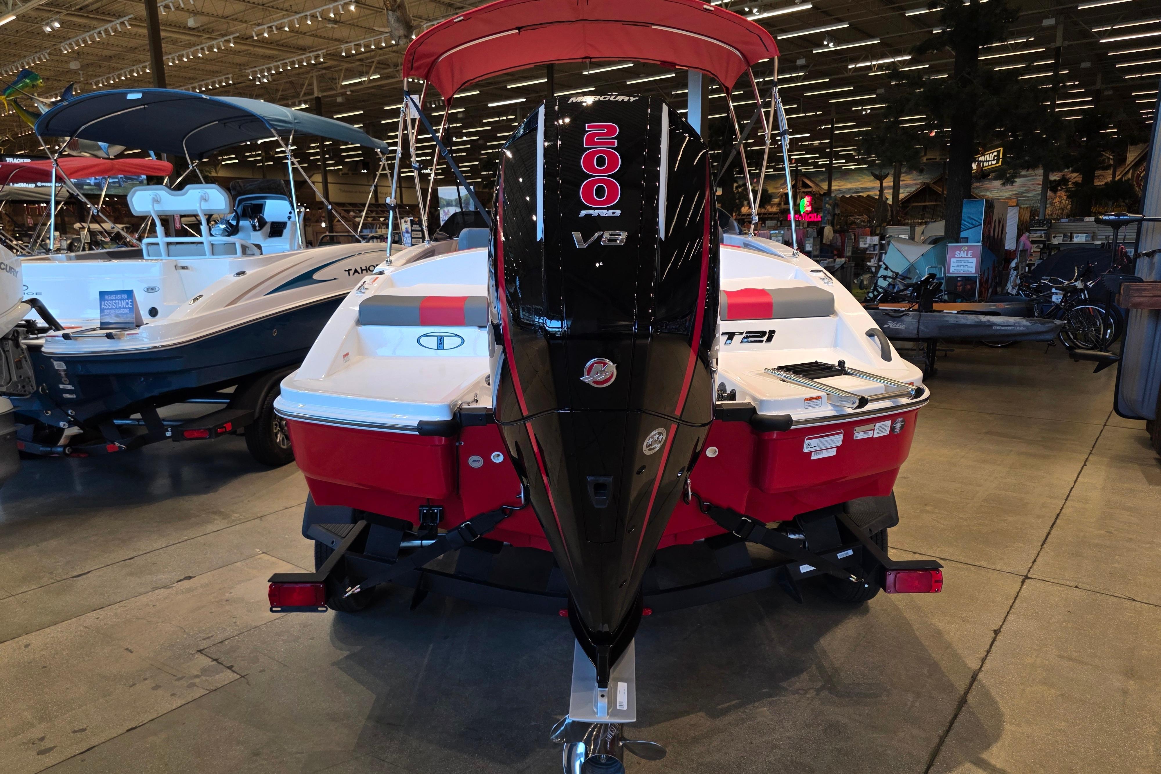 2026 Tahoe T21 boat with 200 Pro V8 engine displayed in showroom.