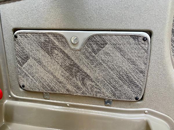 Interior view of a boat with a gray, textured compartment.