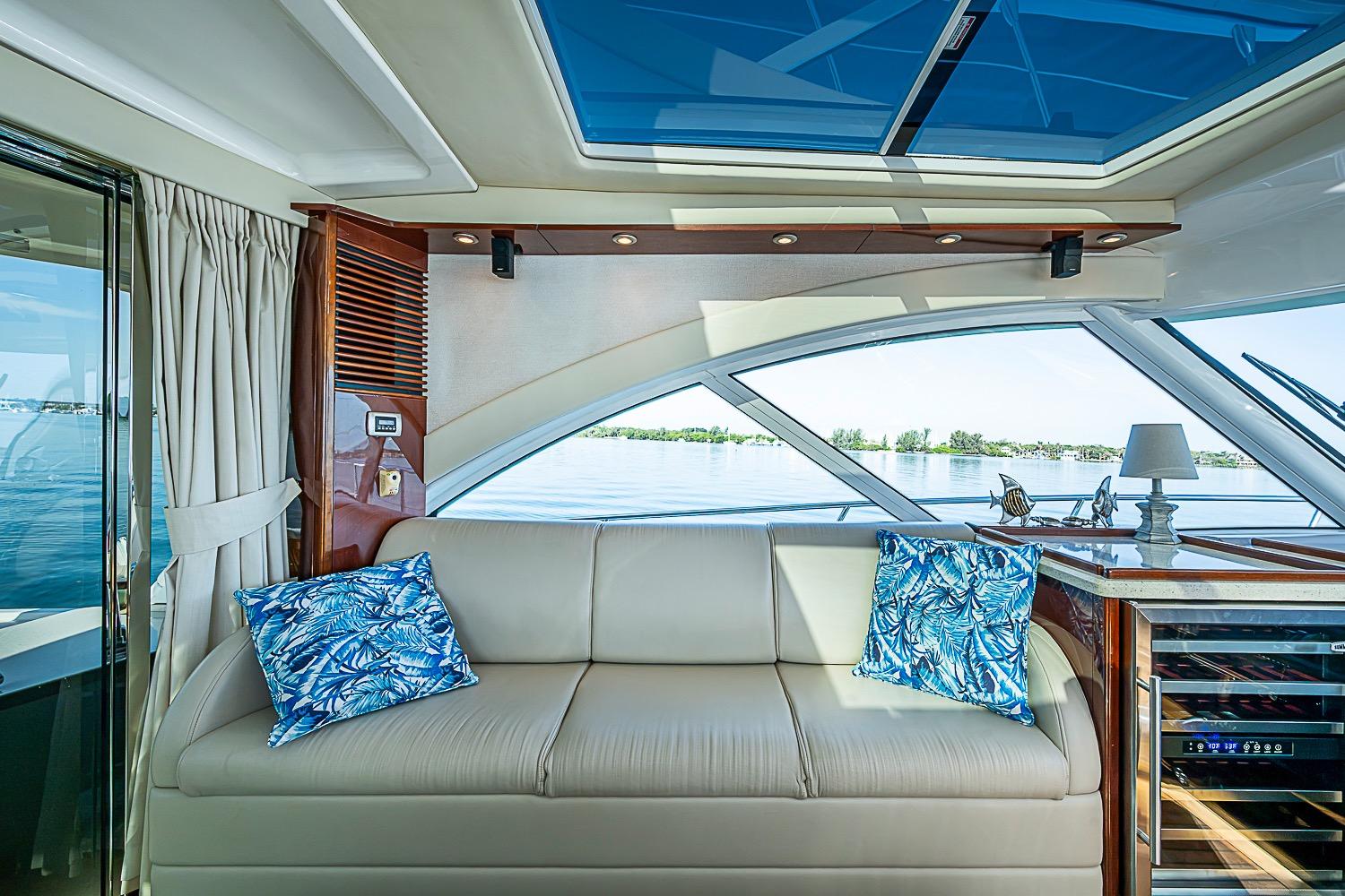 Luxurious interior of 2008 Sea Ray 60 Sundancer yacht with elegant seating and scenic water view.