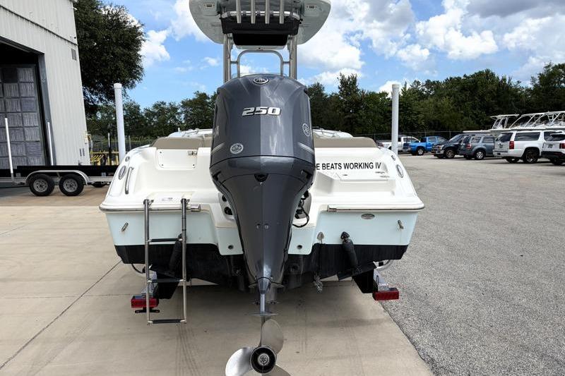 2024 Key West 239 FS boat with 250 HP engine, parked outdoors.