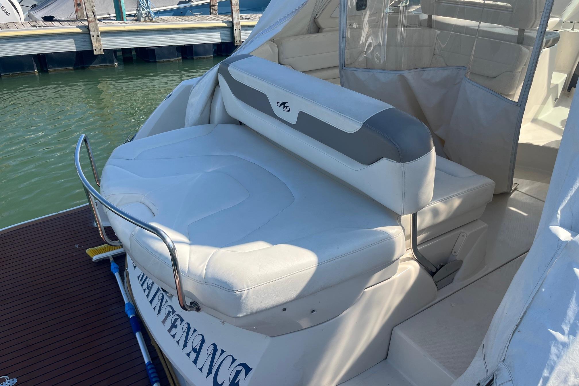 2010 Monterey 400 Sport Yacht with white seating at marina dock.