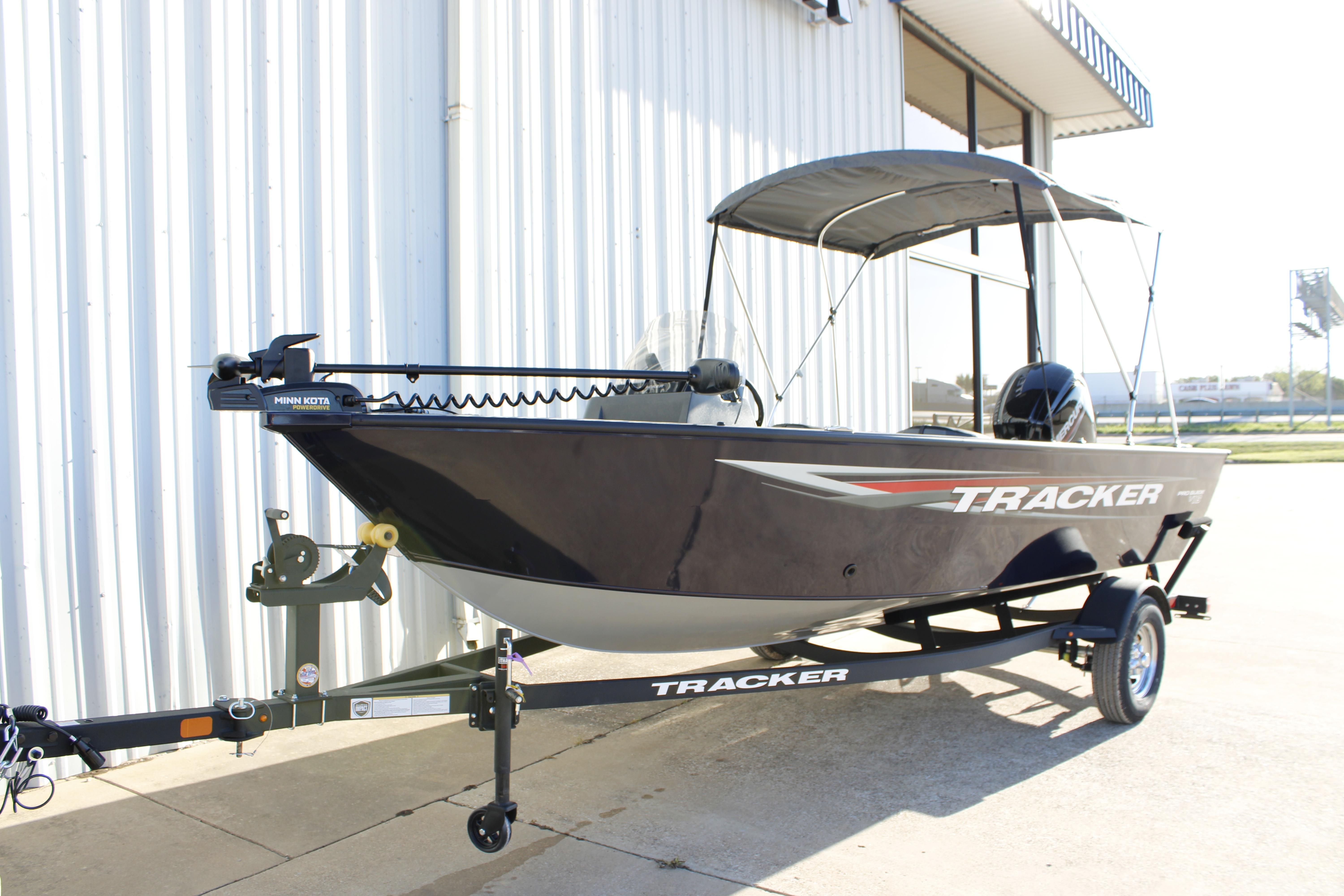 2026 Tracker Pro Guide V-16 SC boat with trailer, parked outdoors.