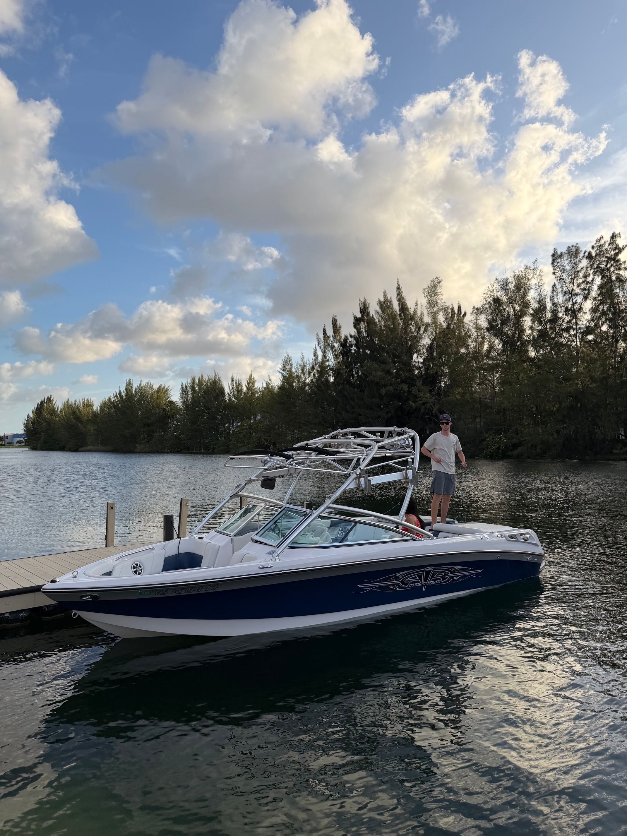 2008 Nautique 236 Team Edition boat docked at sunset.