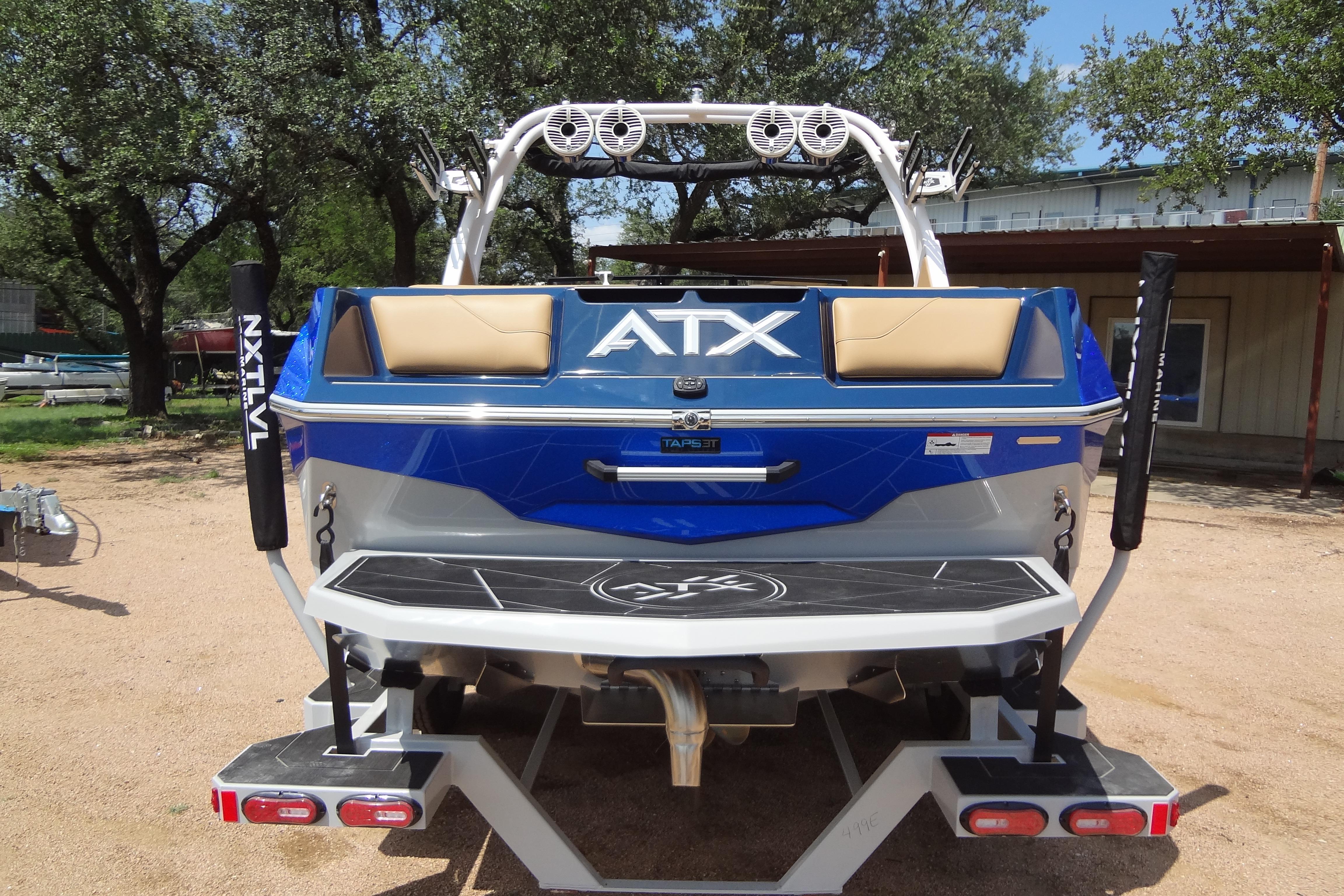 2022 ATX Surf Boats 24 Type-S, blue and white, rear view with speakers and swim platform.