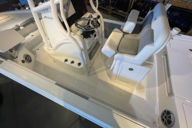 2026 Mako 24 APEX boat interior with steering console and cushioned seating.