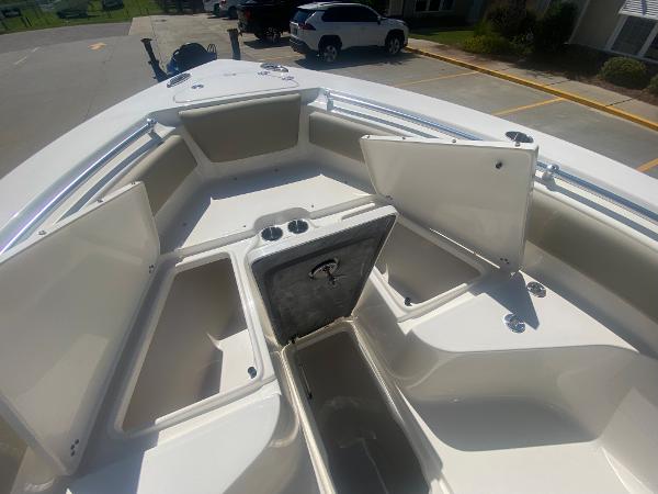 2024 Key West 239 FS boat with open storage compartments.