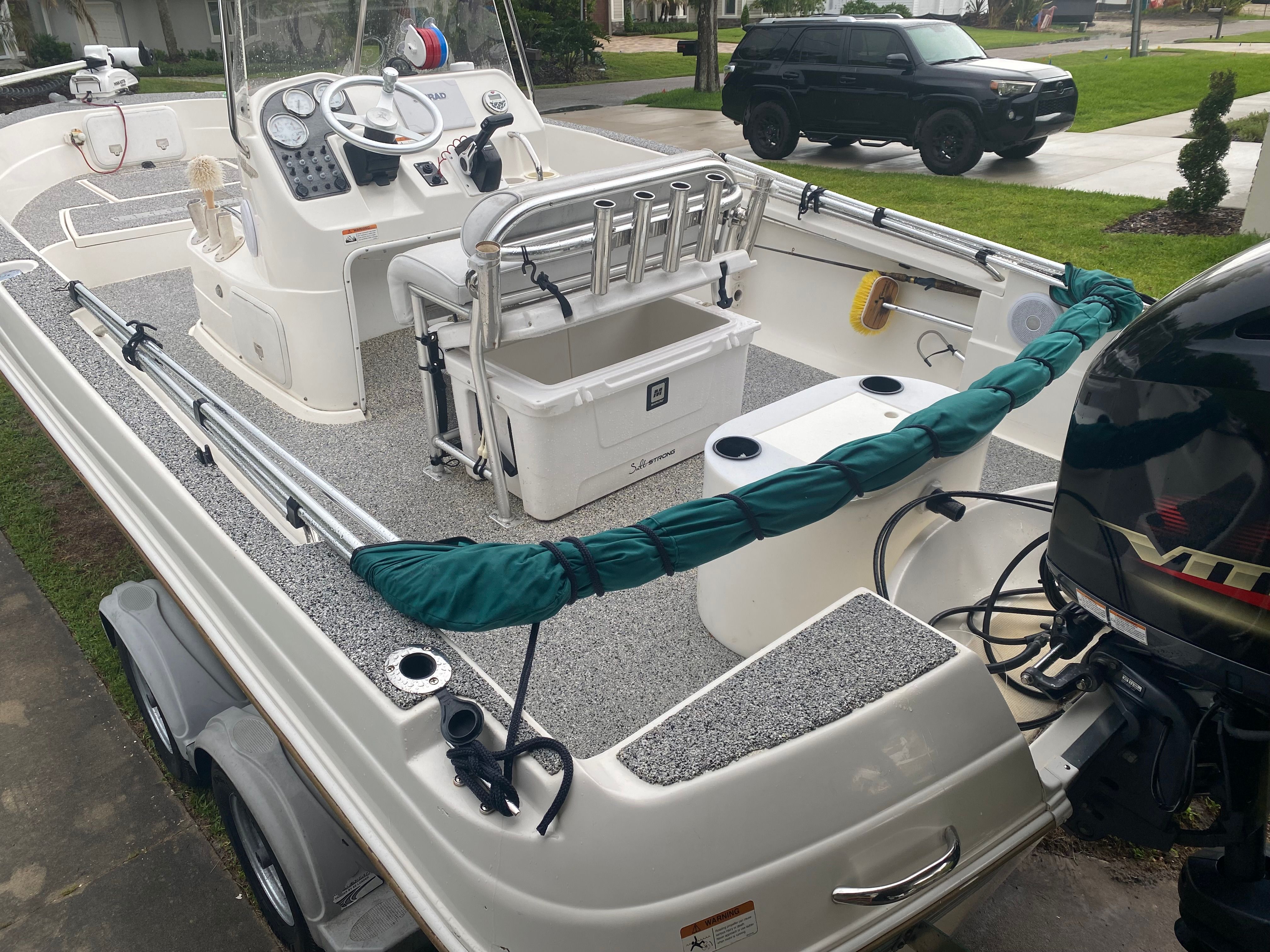The image shows a 2003 Aquasport 201 Osprey boat on a trailer. It features an open helm and outboard motor.