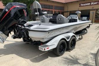 2026 Nitro Z21 XL Pro boat with dual axle trailer parked outside a Tracker Boat dealership.