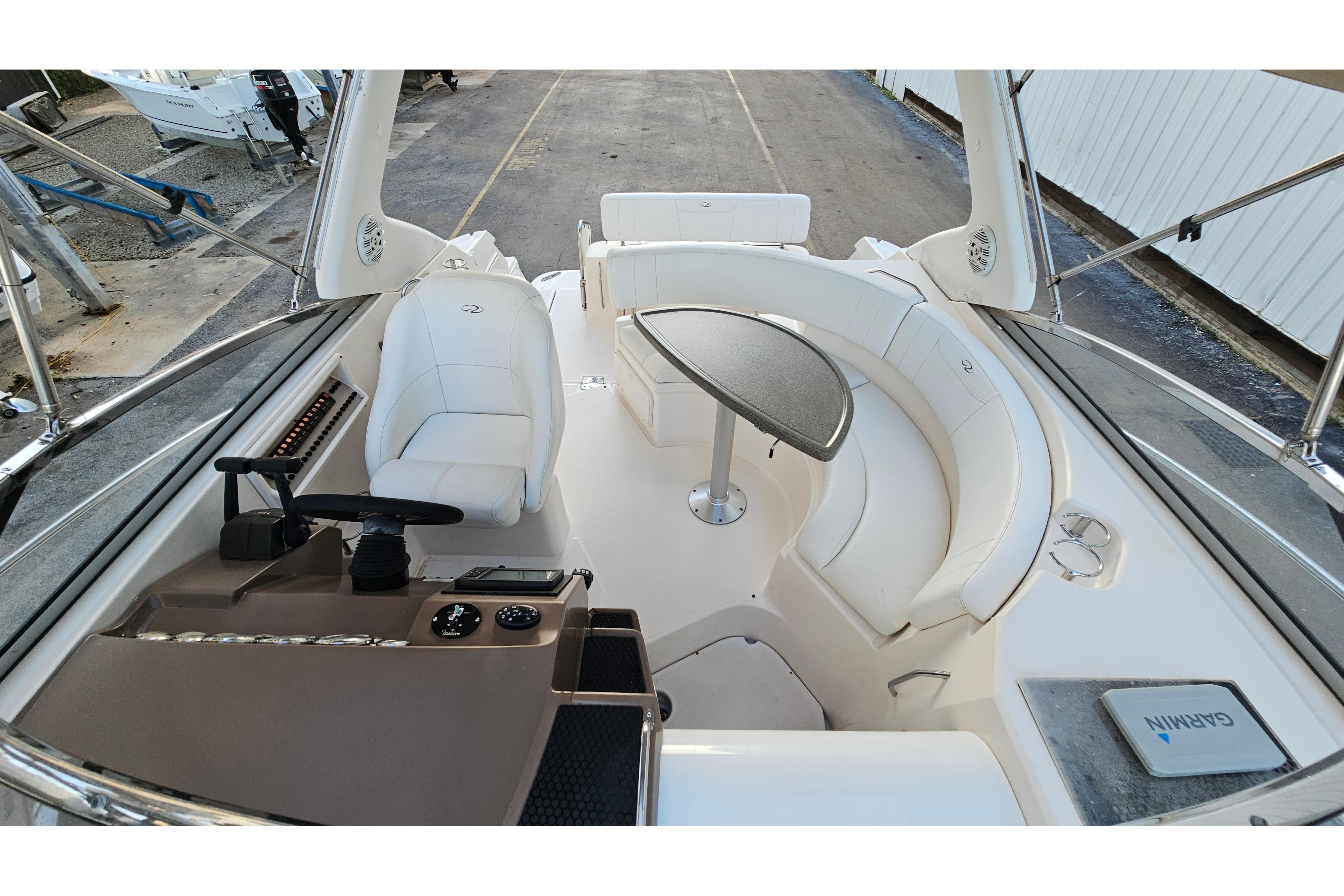 2005 Regal 3060 Window Express boat interior with helm, seating, and table.