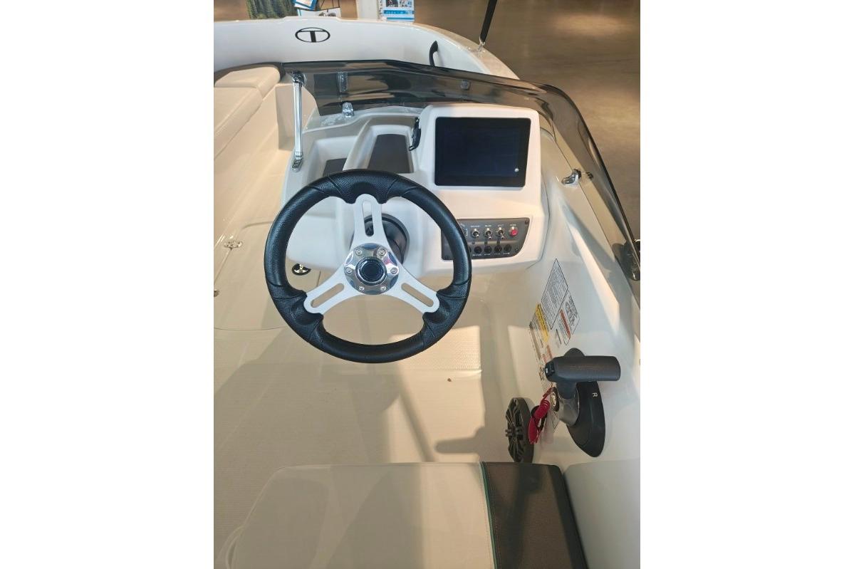 2026 Tahoe T16 boat cockpit with steering wheel and control panel.