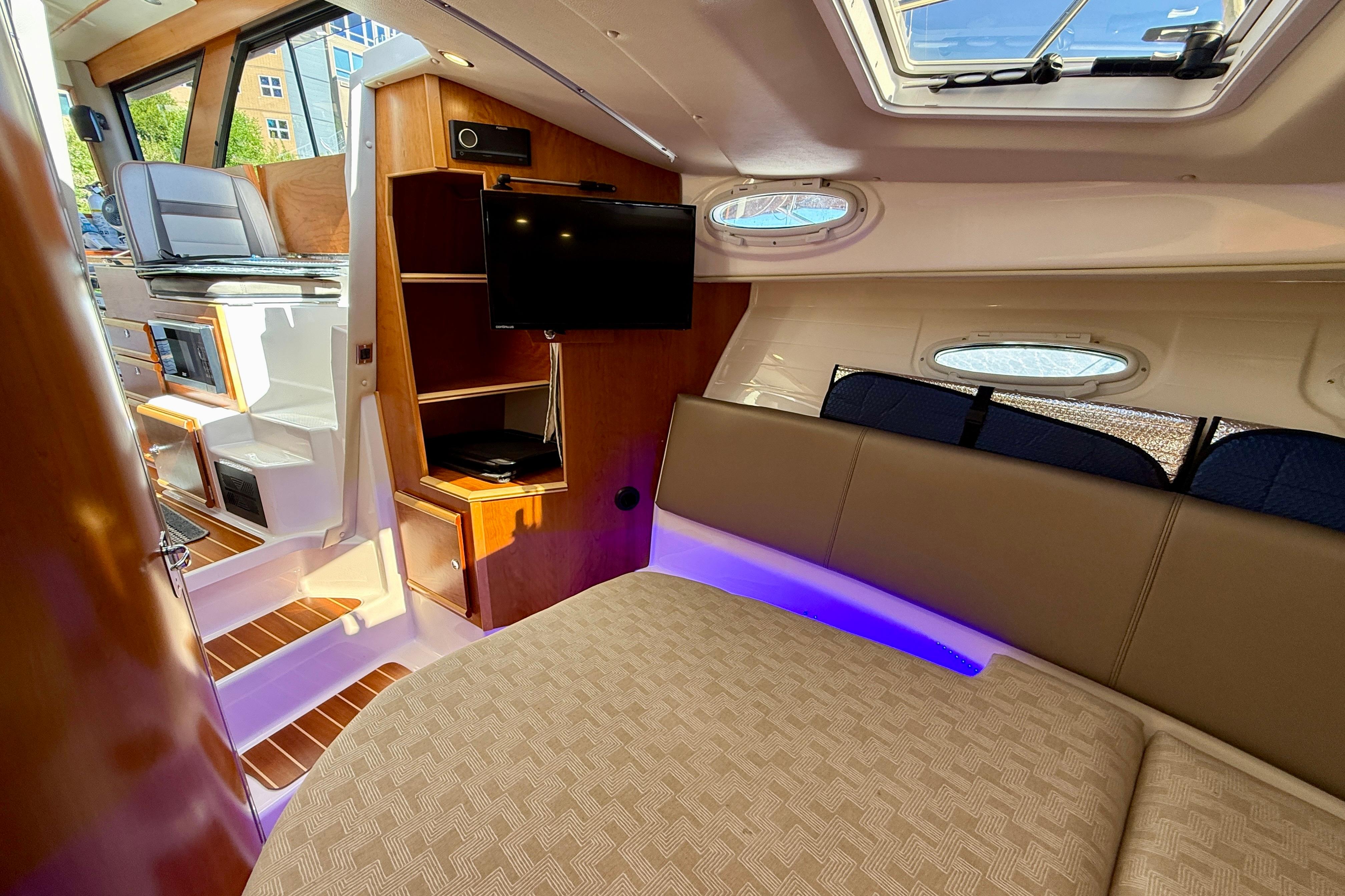 2023 Cutwater C-30 Sedan interior with modern amenities, featuring a cozy seating area and entertainment system.