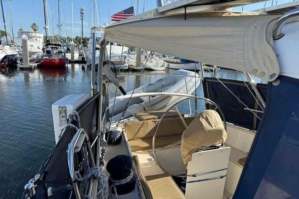Sailboat Reliance 44, 2011 model, docked at marina with American flag in background.