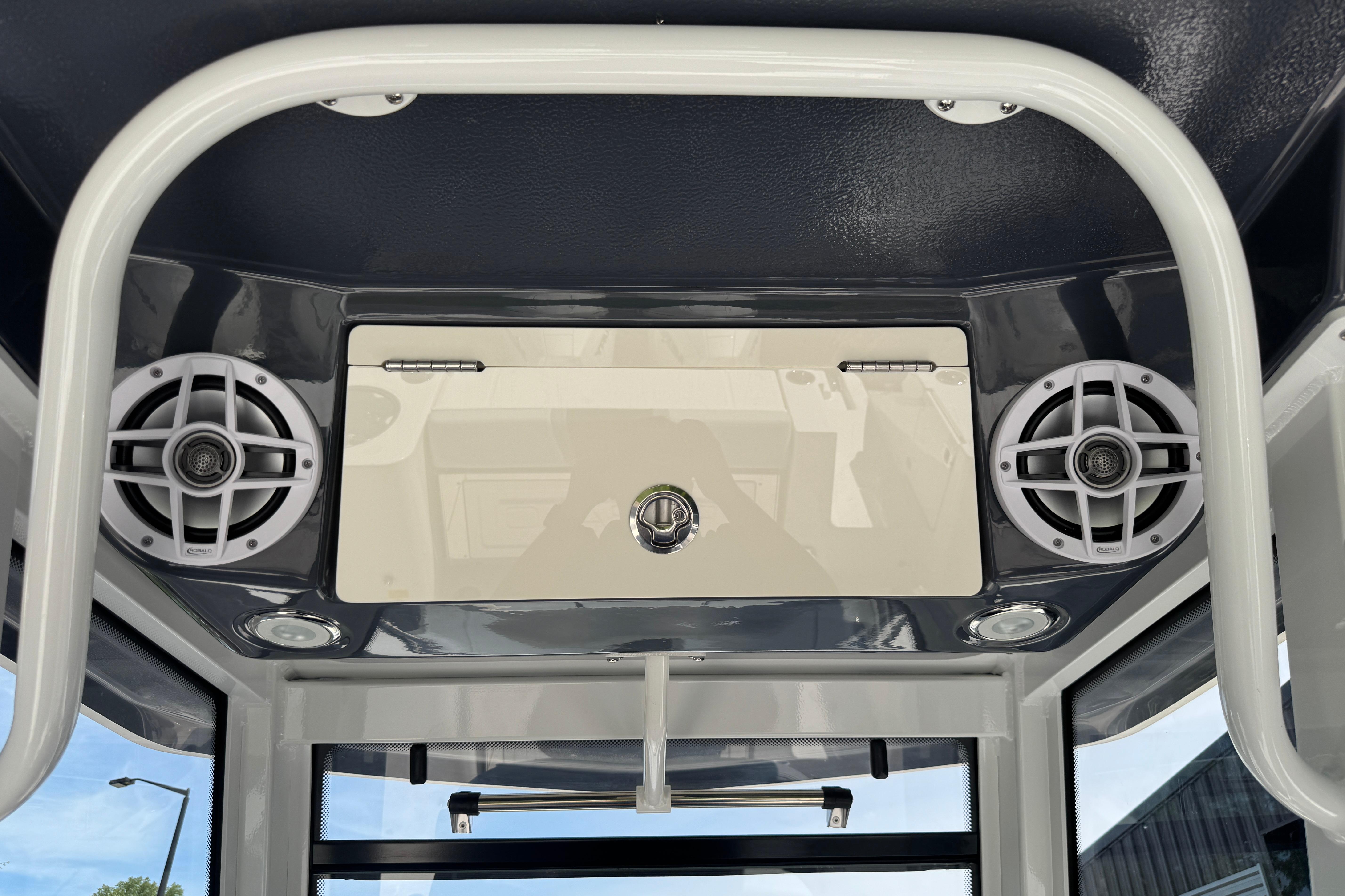 2026 Robalo R250 Center Console boat speakers and storage compartment detail.