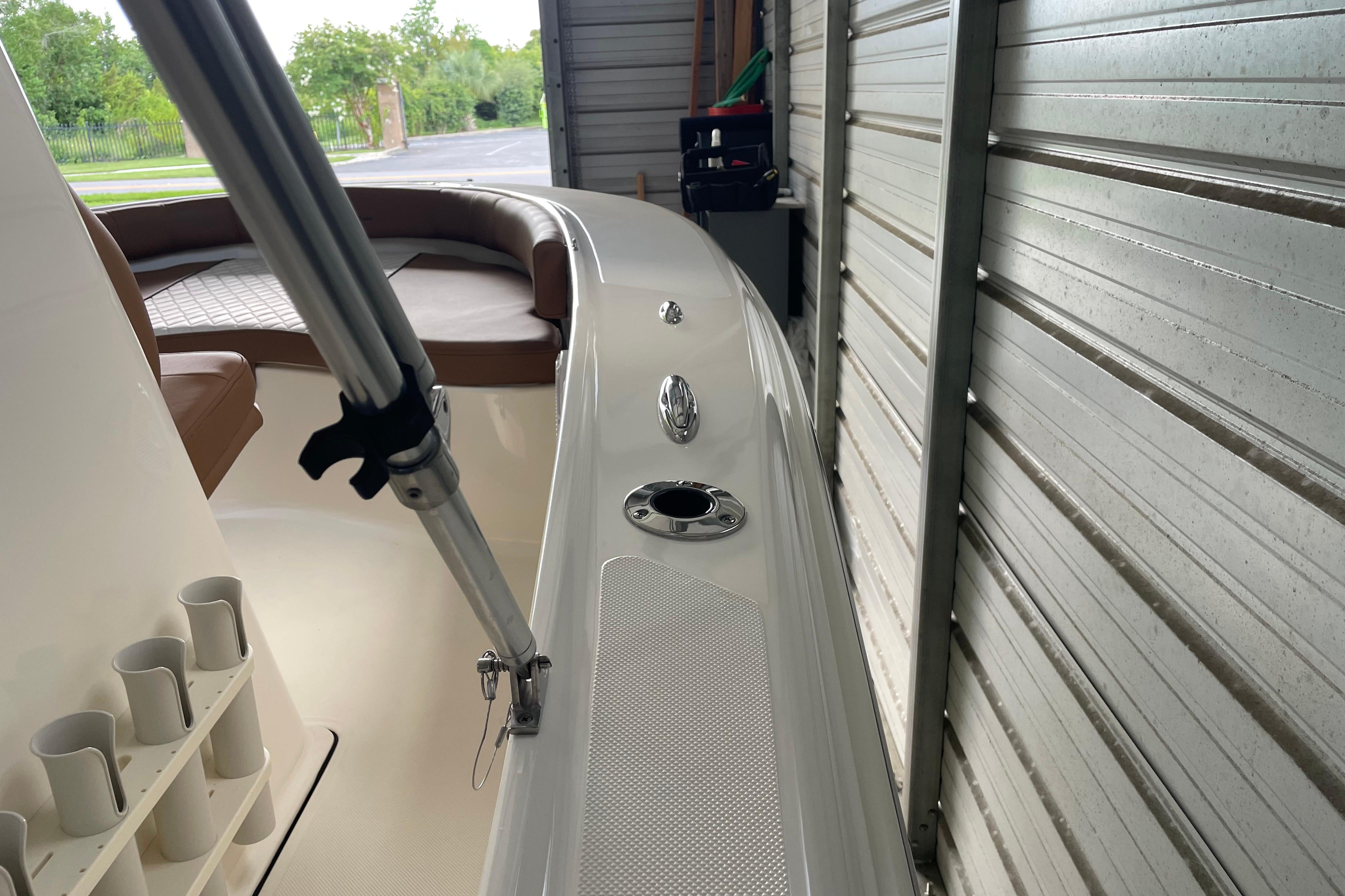 2024 Pioneer 180 Islander boat interior with seating and rod holders in storage.