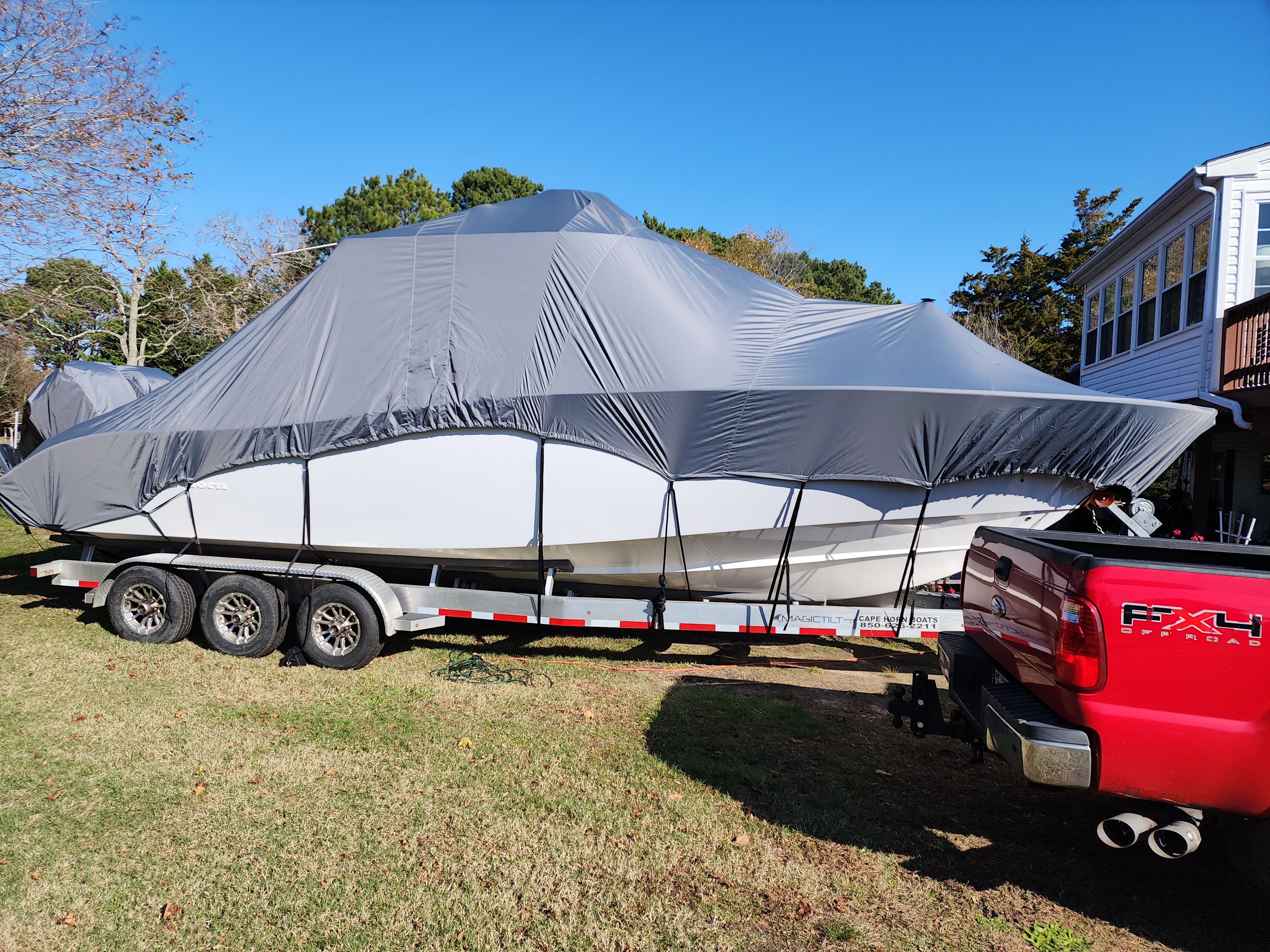 Covered Cape Horn 32 XS boat on trailer, 2021 model.
