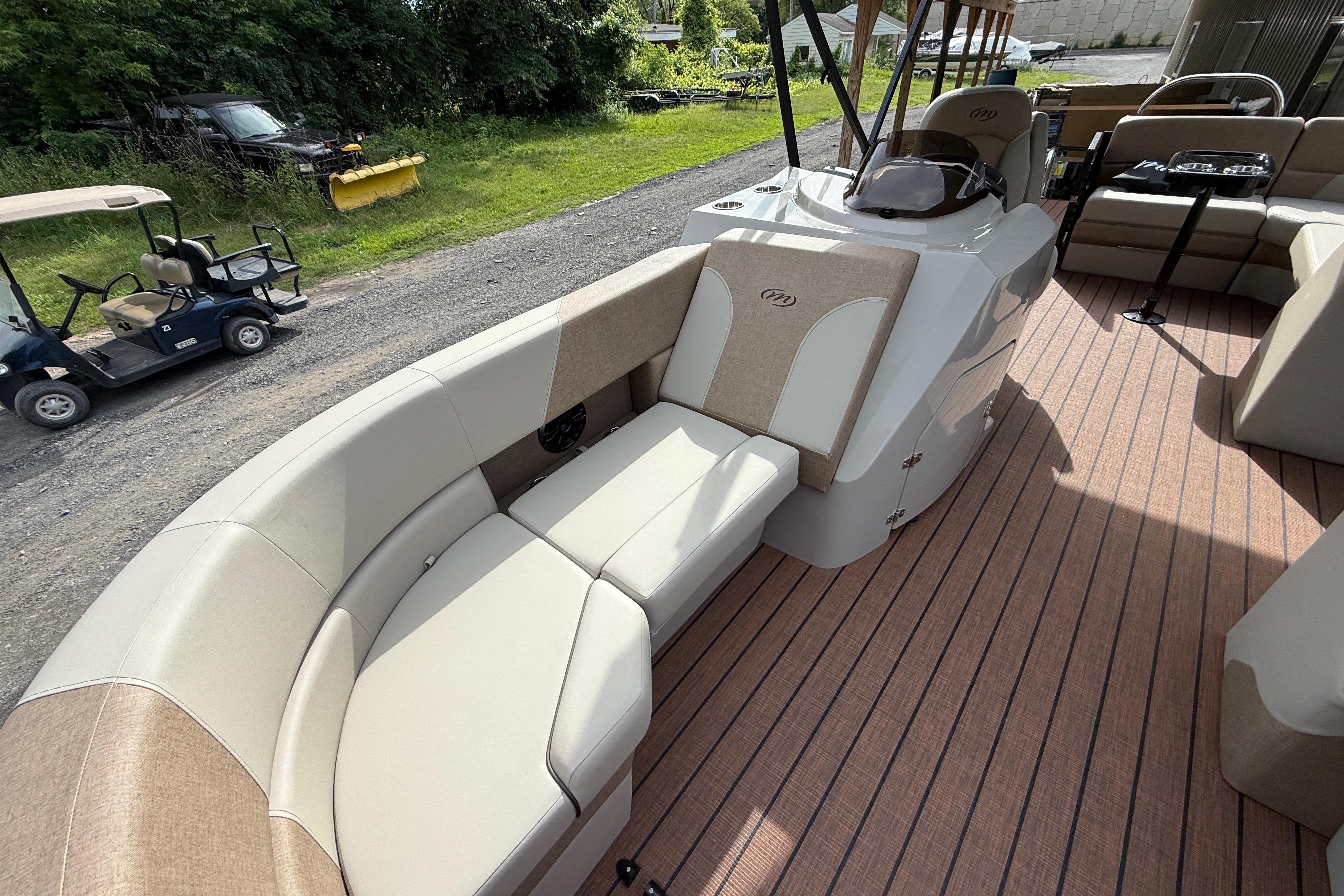 2027 Manitou 21 Aurora LE pontoon boat with spacious seating and elegant interior design.