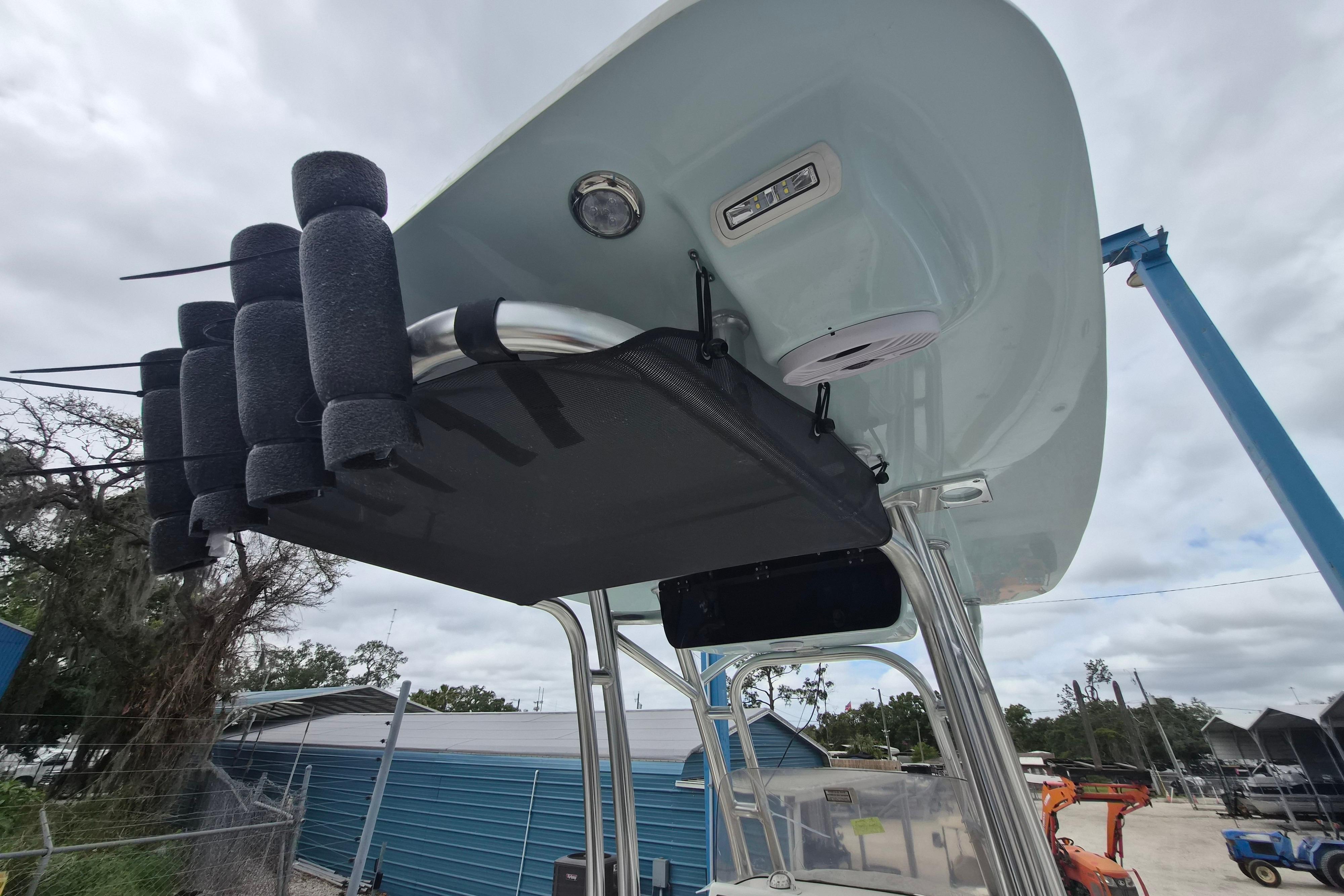 2026 Key West 219 FS boat with rod holders and T-top, docked outdoors.