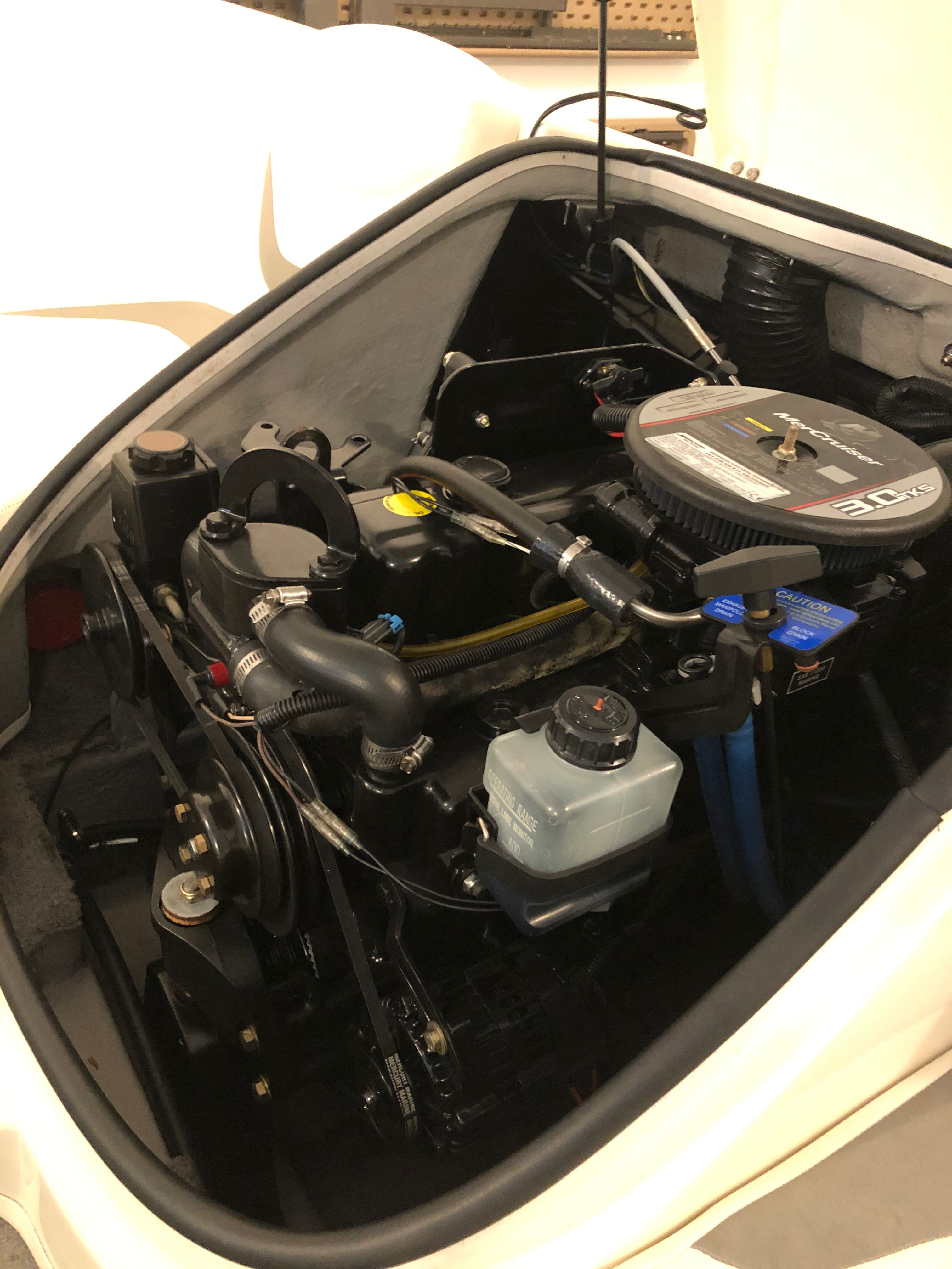 An engine compartment of a Bayliner 175 Bowrider boat with visible components.