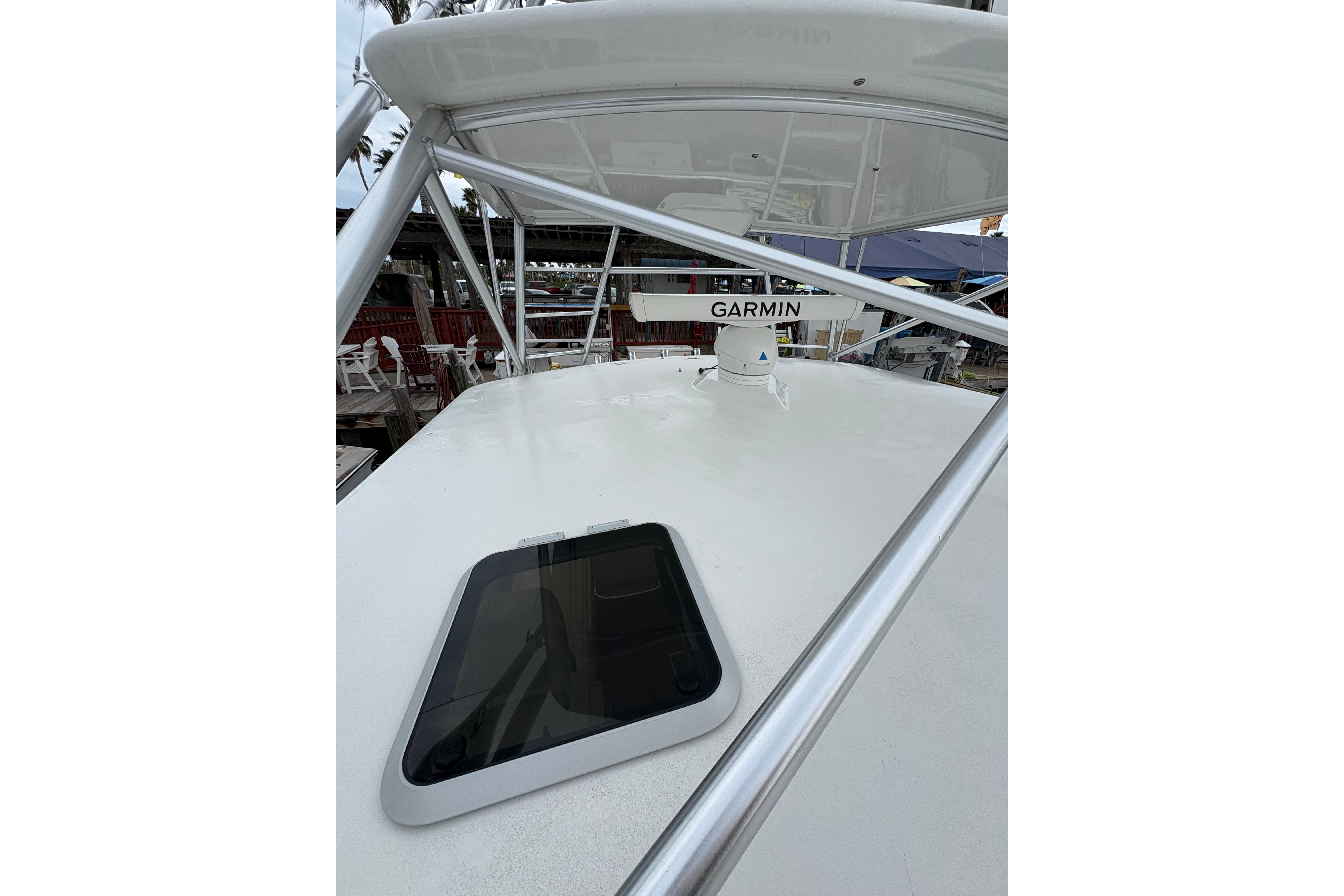 2004 Cabo 40 Hardtop Express boat with Garmin radar and hatch on deck.
