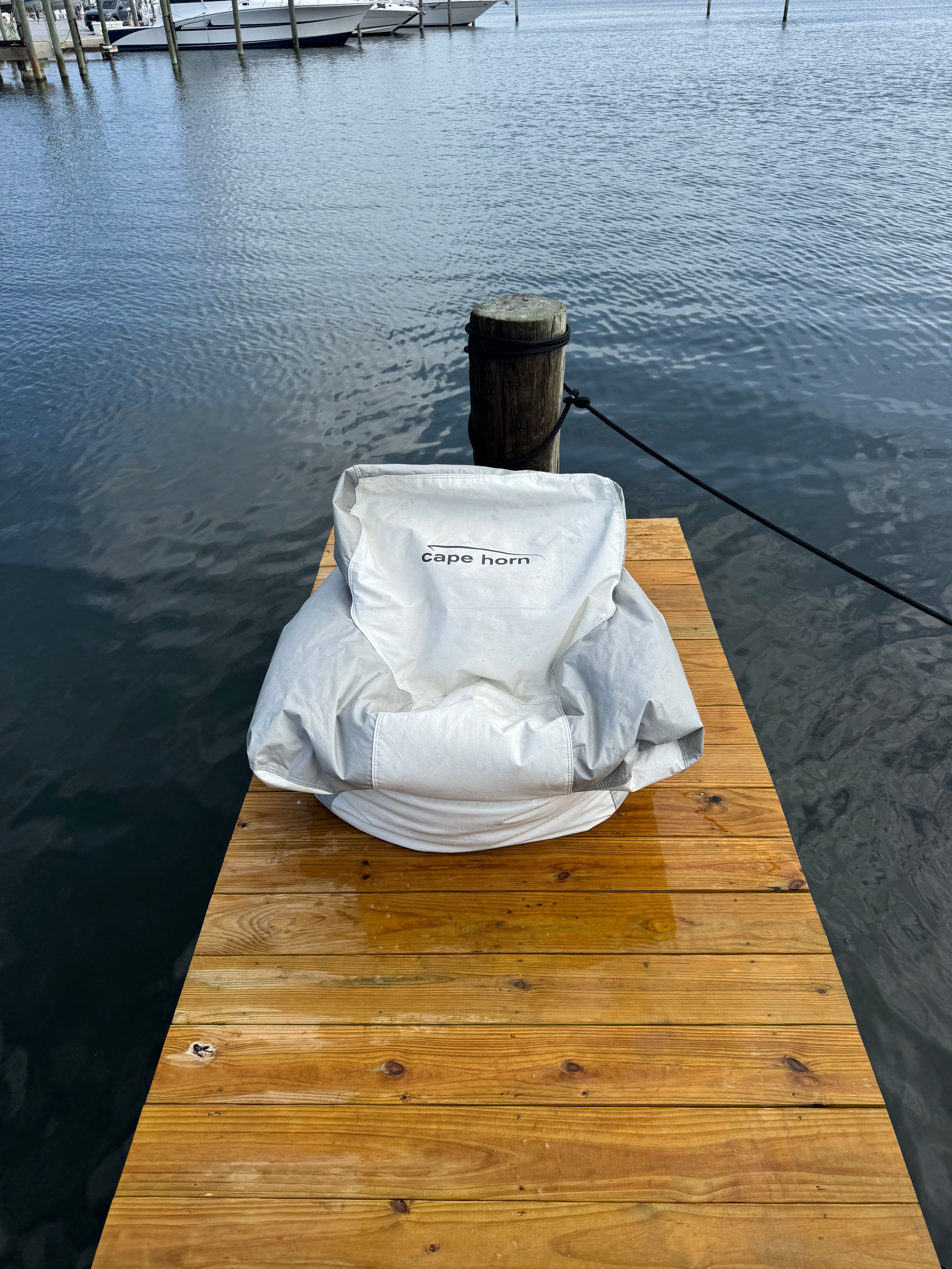A Cape Horn boat on a wooden dock, covered with a protective cover.