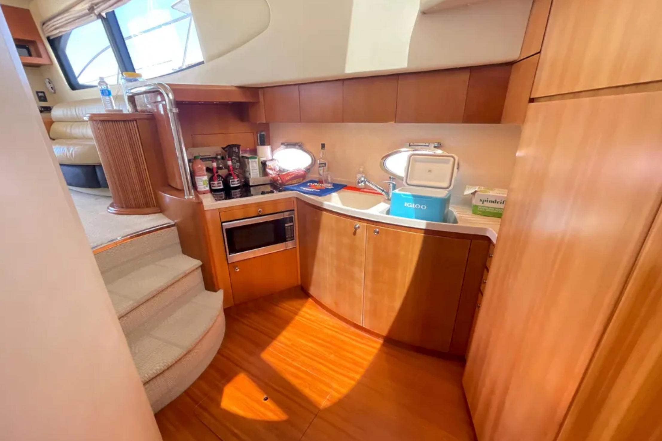 Luxurious 2004 Azimut 46 yacht interior with modern kitchen and wooden cabinetry.