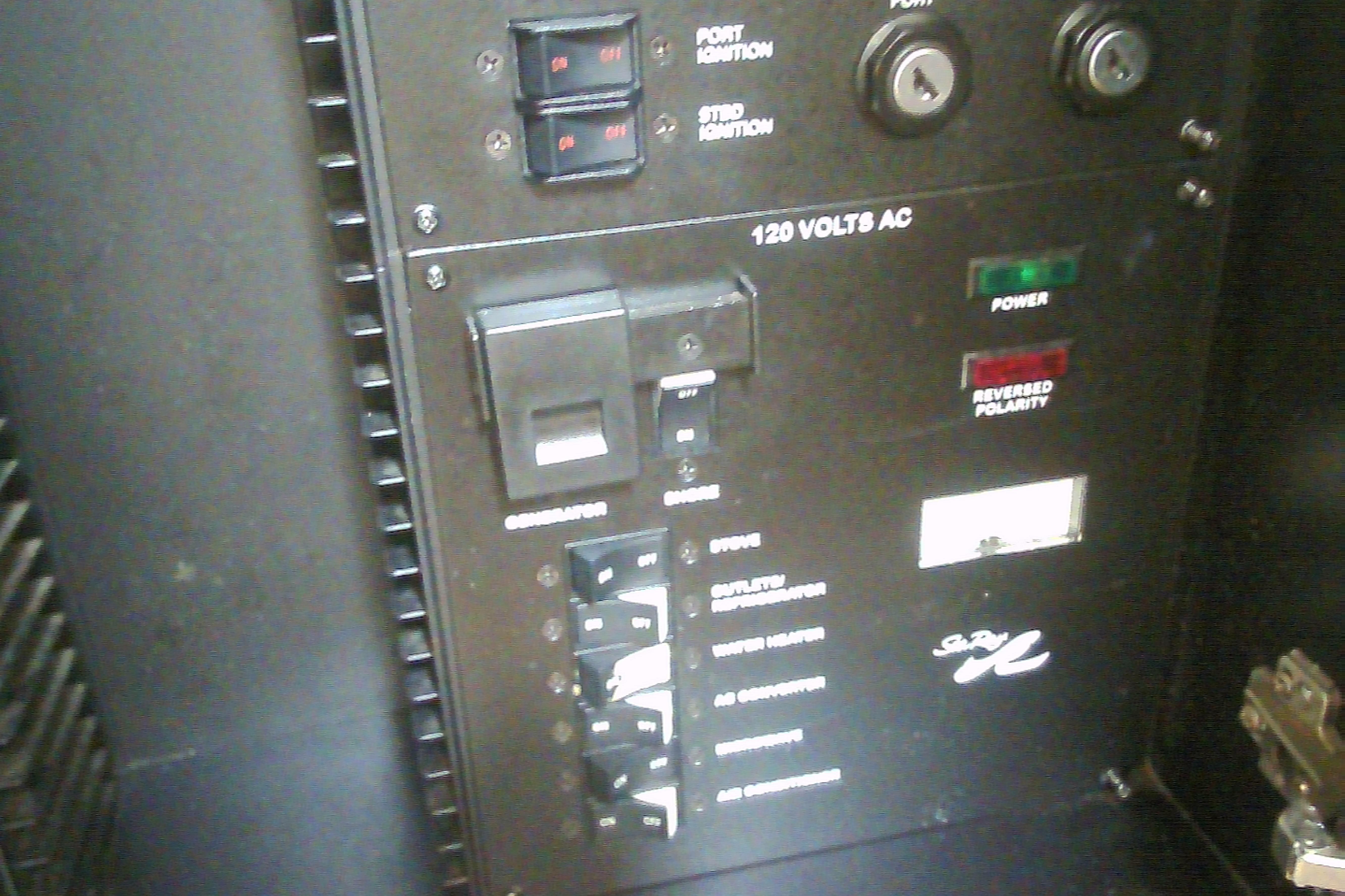 Electrical panel of 2005 Sea Ray 300 Sundancer boat, showing switches and indicators.