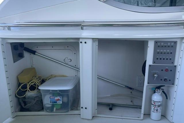 1999 Formula 400 Super Sport boat storage area with equipment and fire extinguisher.