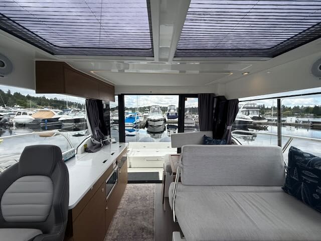 Interior of a 2021 Jeanneau NC 1095 with modern design and large windows.