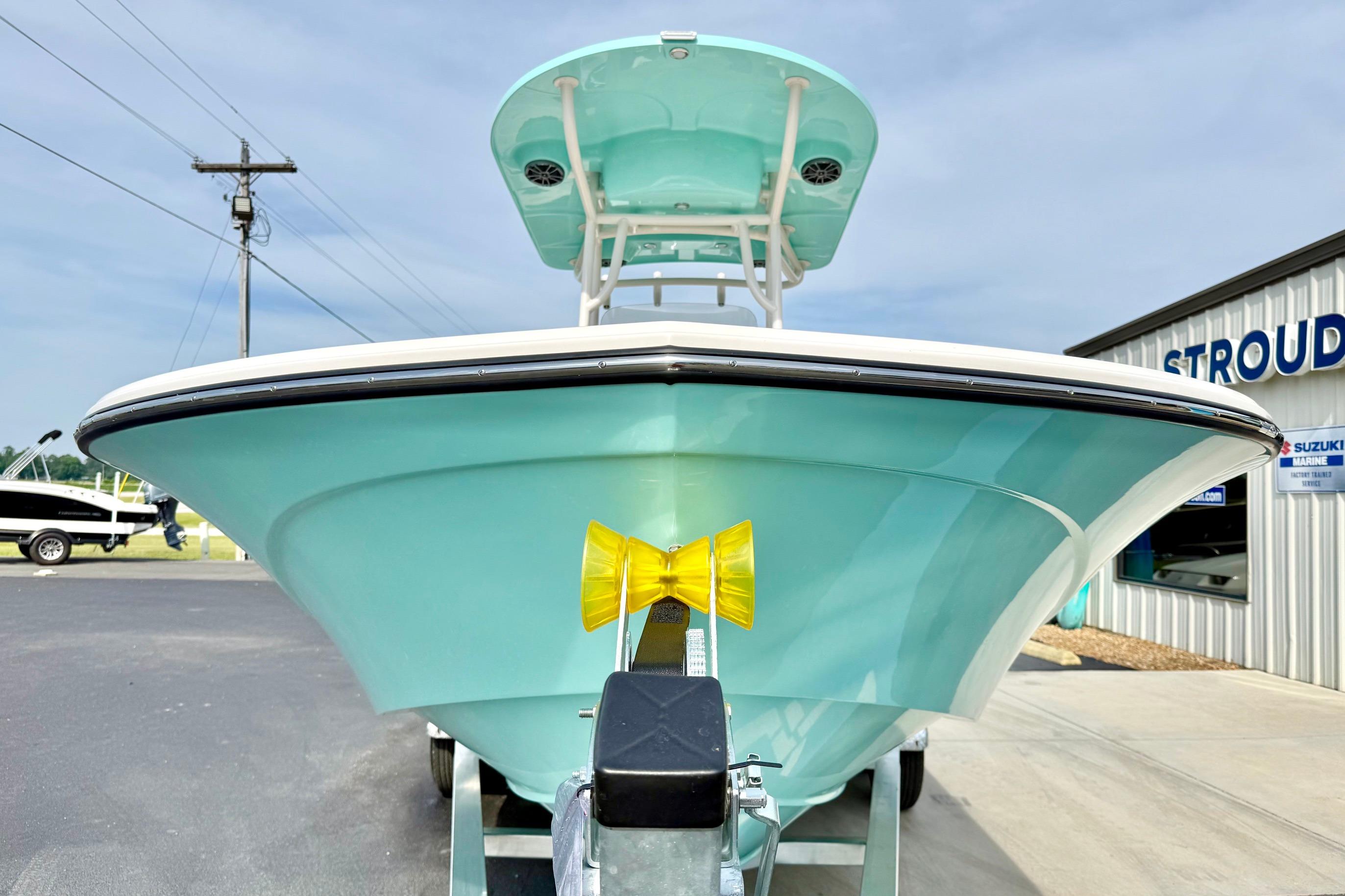 2026 Carolina Skiff 24 Ultra Elite boat in light blue, displayed outdoors at a dealership.