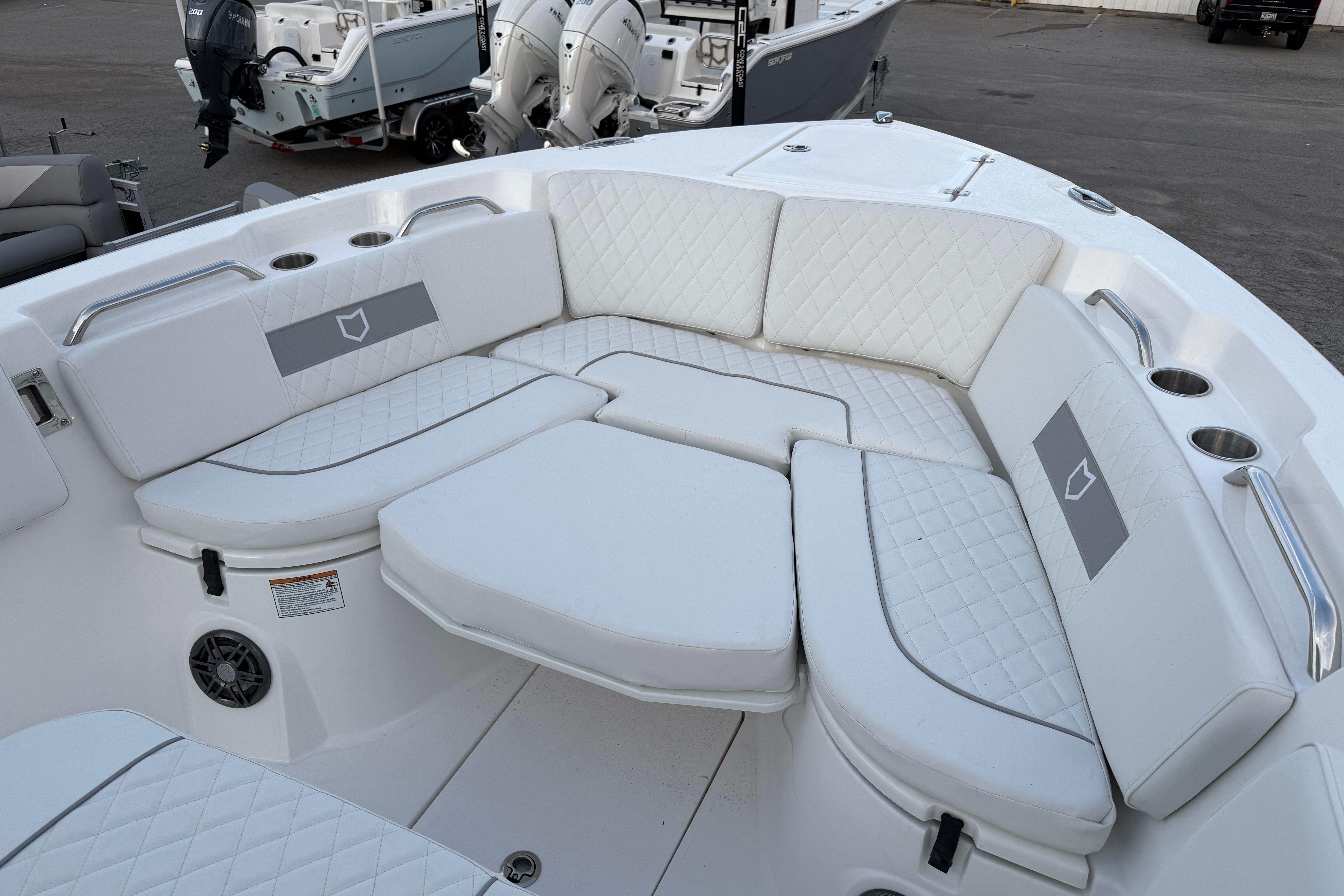 2026 Sea Fox 268 Commander boat with luxurious white seating and cup holders.