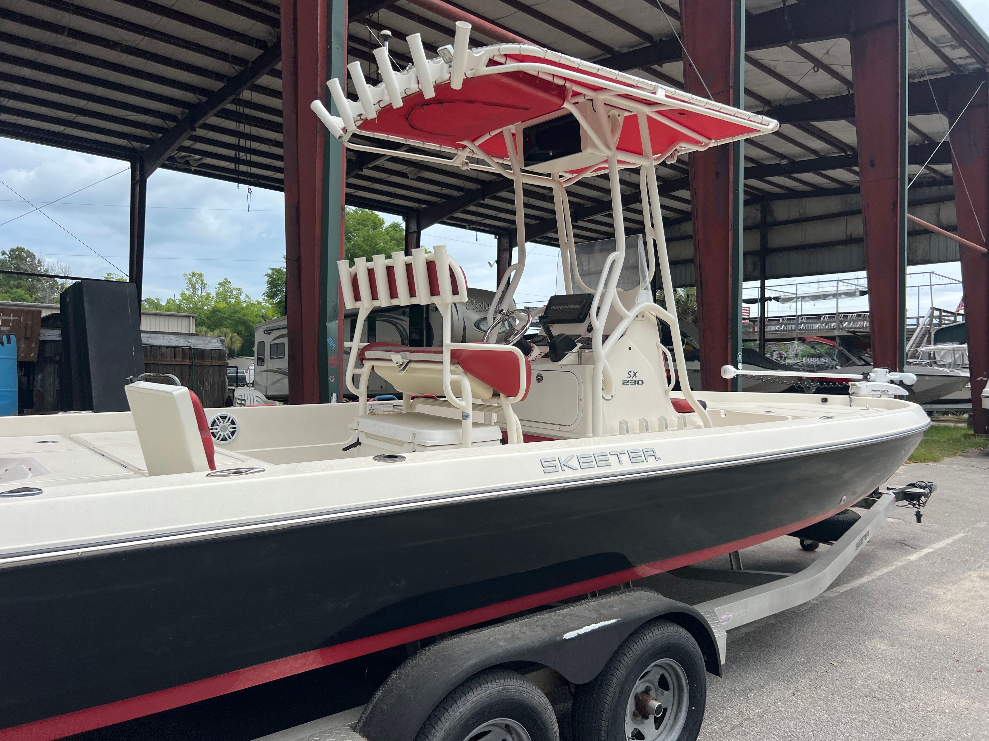2016 Skeeter SX230 boat with red canopy on trailer.