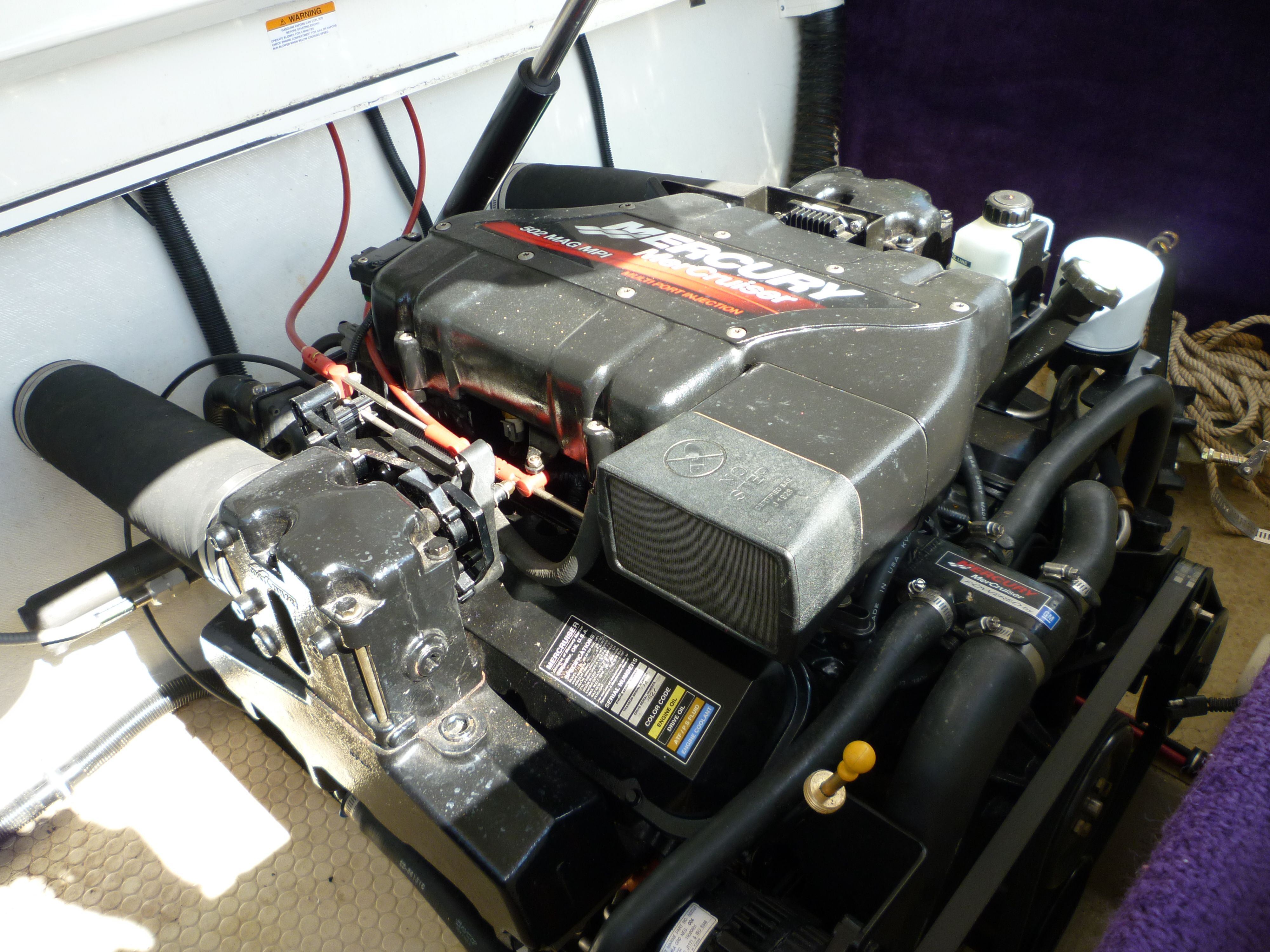 Engine compartment of a 2000 Velocity 280 boat with a Mercury engine.