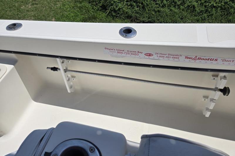 Interior view of a 2000 May-Craft 2000CC boat, featuring rod holders and storage.