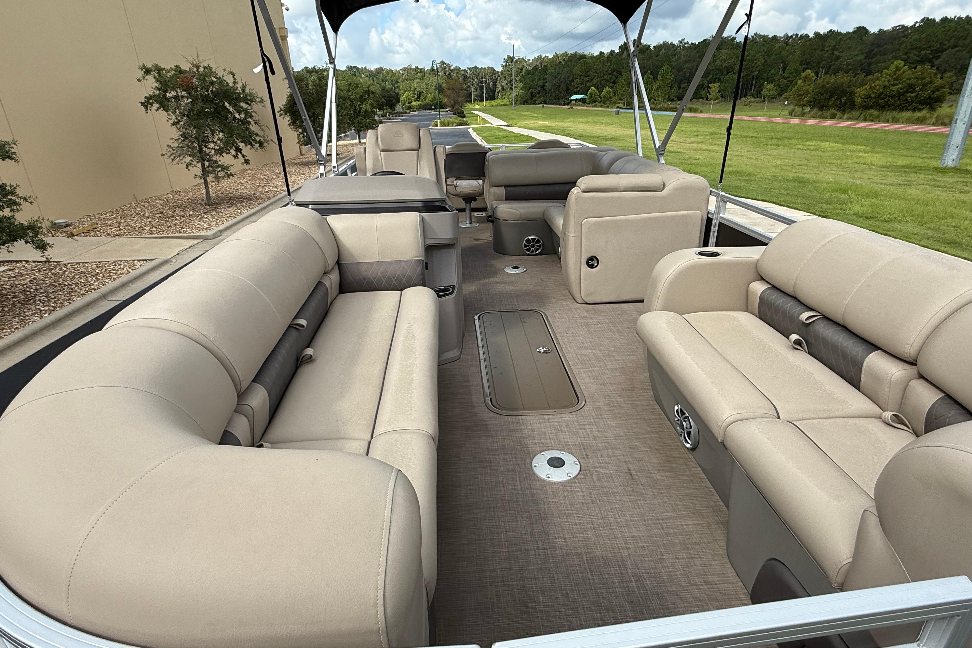 2024 Sun Tracker SportFish 22 XP3 pontoon boat interior with spacious seating and canopy.