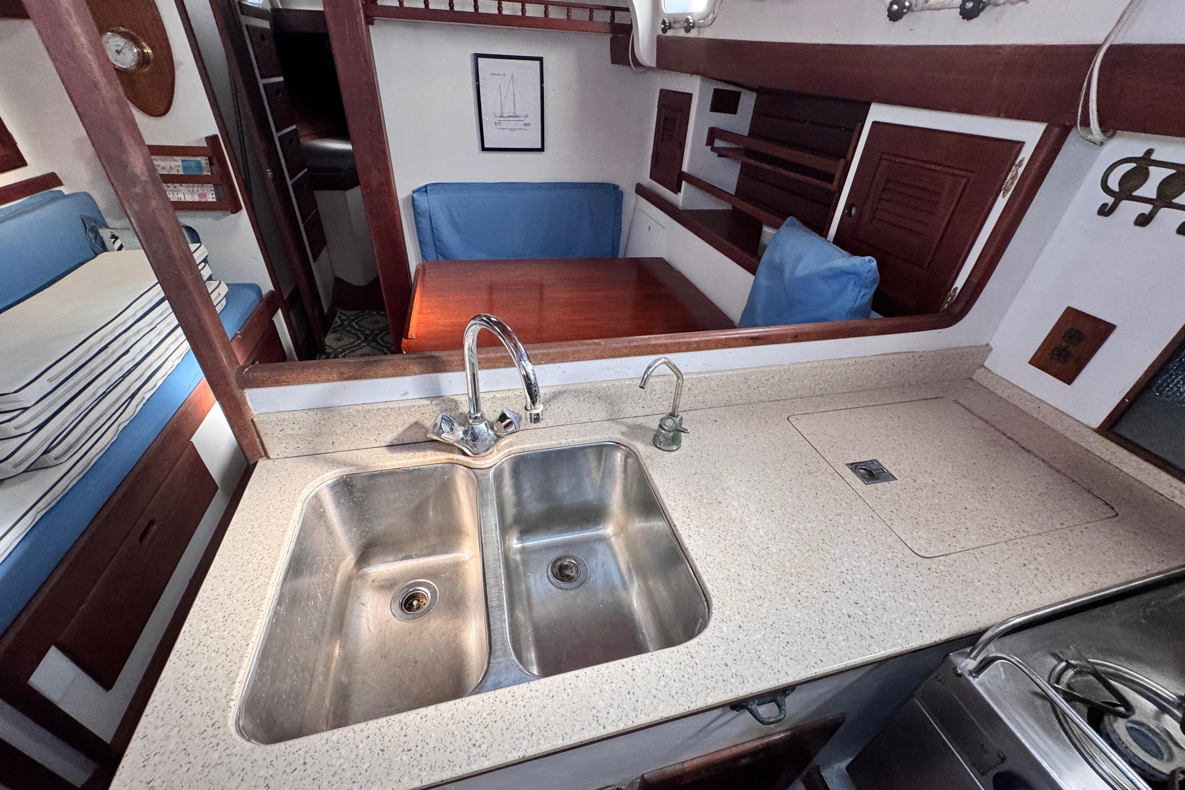 Interior of 1980 Dickerson Center Cockpit Ketch with kitchen sink and dining area.