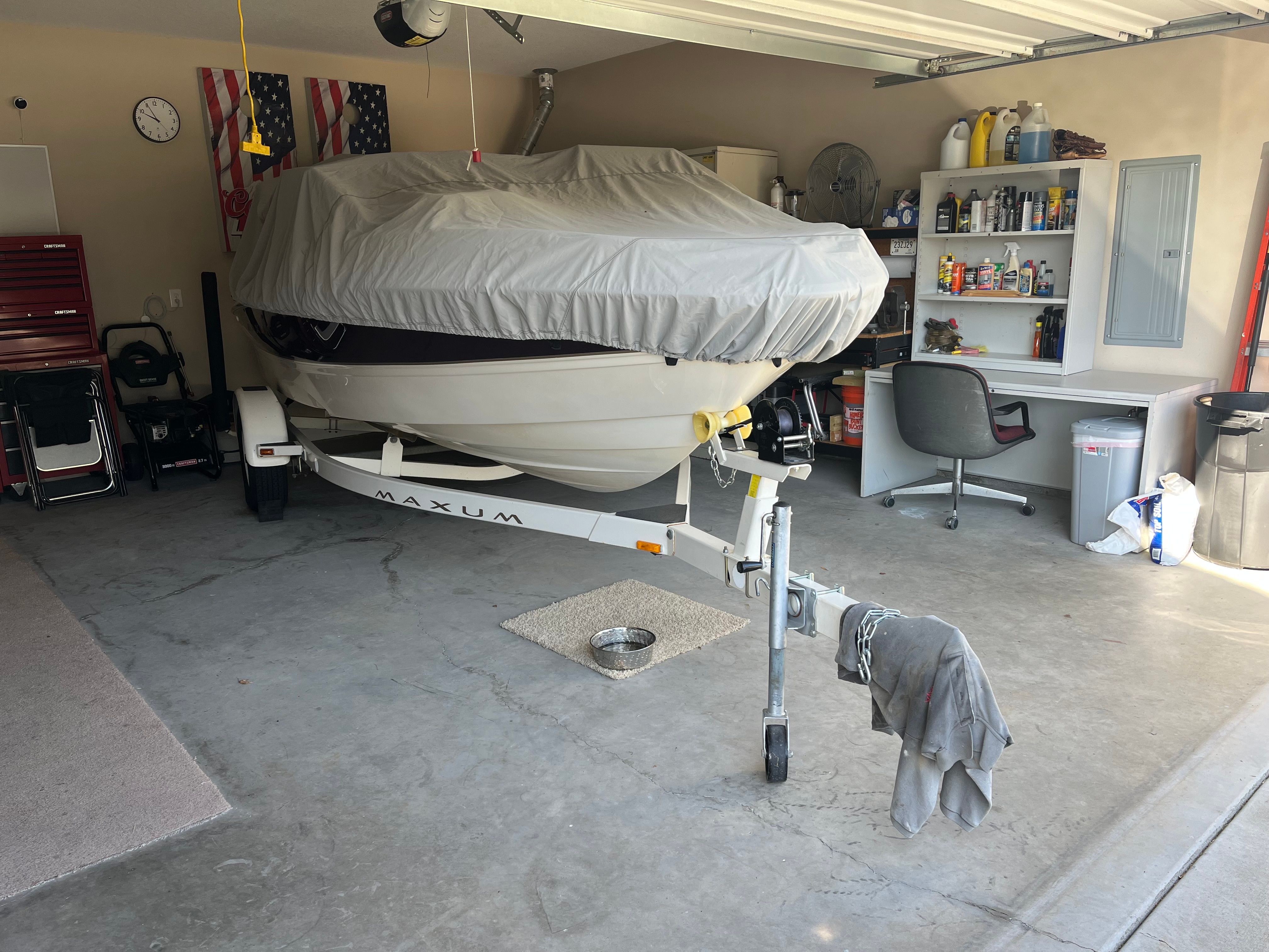 1999 Maxum 1800 SR boat in garage with cover.