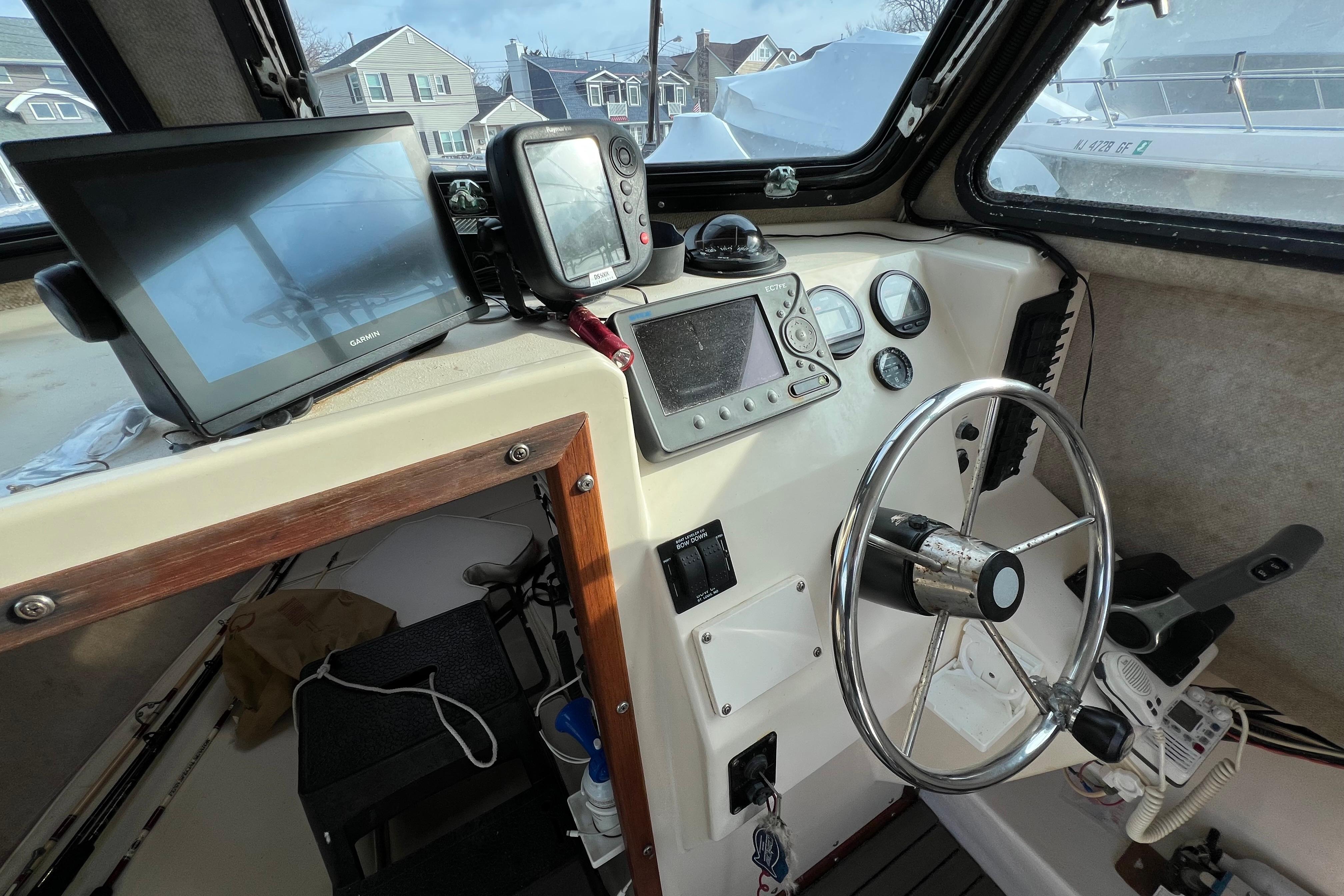 Interior of 2001 Parker 2520 Deep Vee Sport Cabin with steering wheel and navigation equipment.