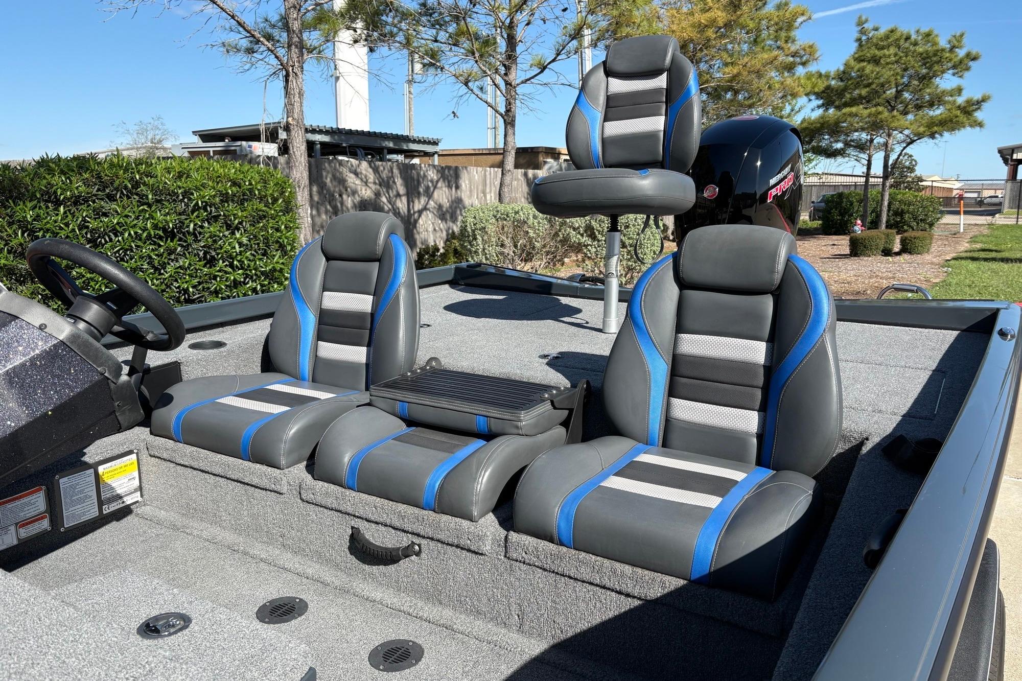 2024 Ranger RT198P boat interior with gray and blue seating under clear skies.