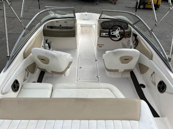 2013 Regal 1900 boat interior with white and beige seating, steering console, and windshield.