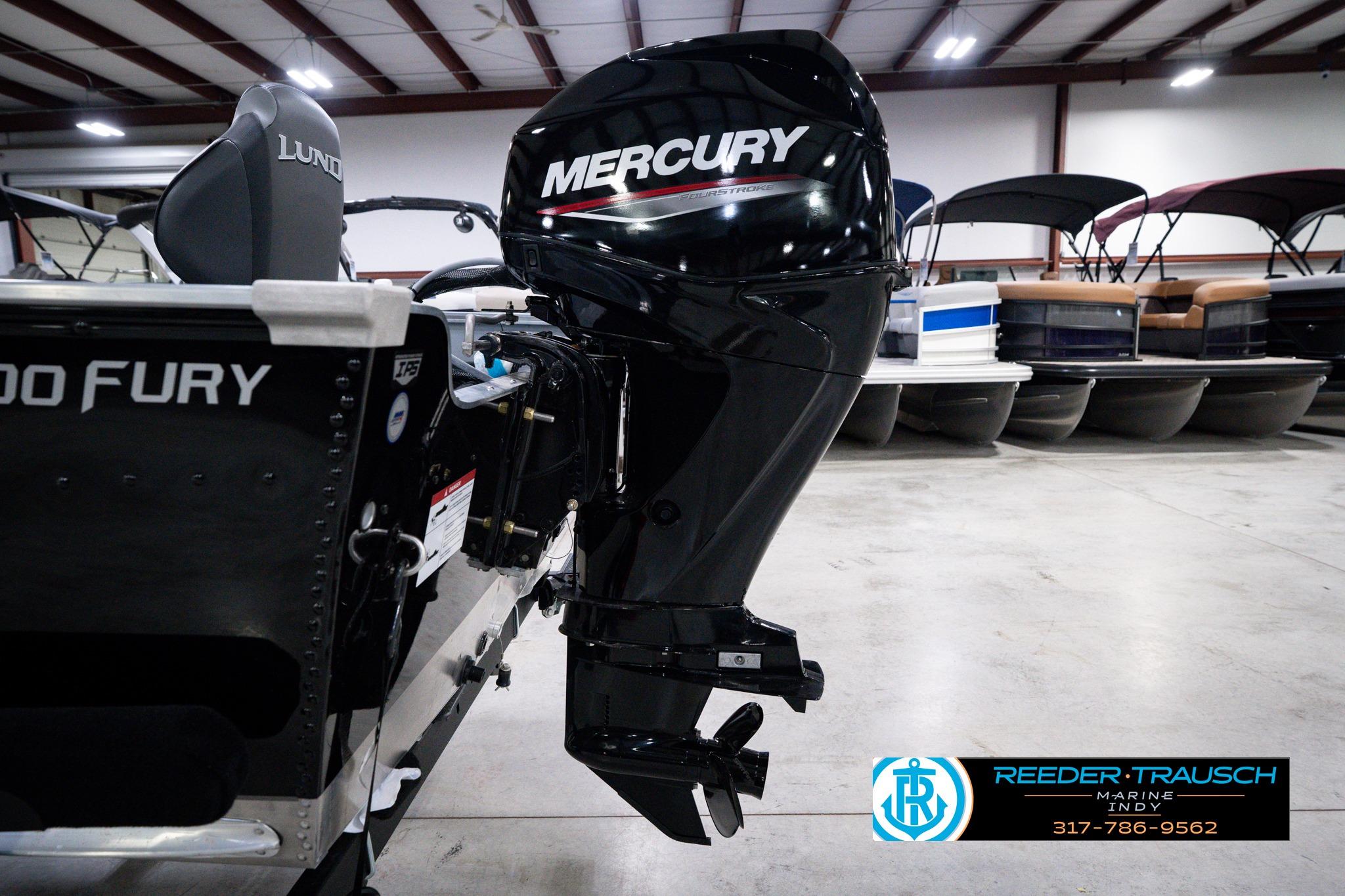 2026 Lund 1600 Fury SS boat with Mercury outboard motor in showroom.