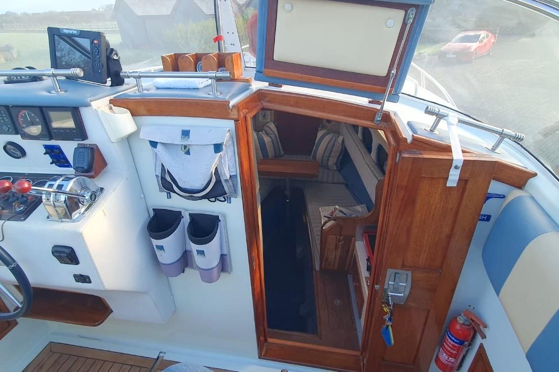 Interior view of 1989 Fairey Spearfish MKIII boat cockpit with wooden finish and navigation equipment.