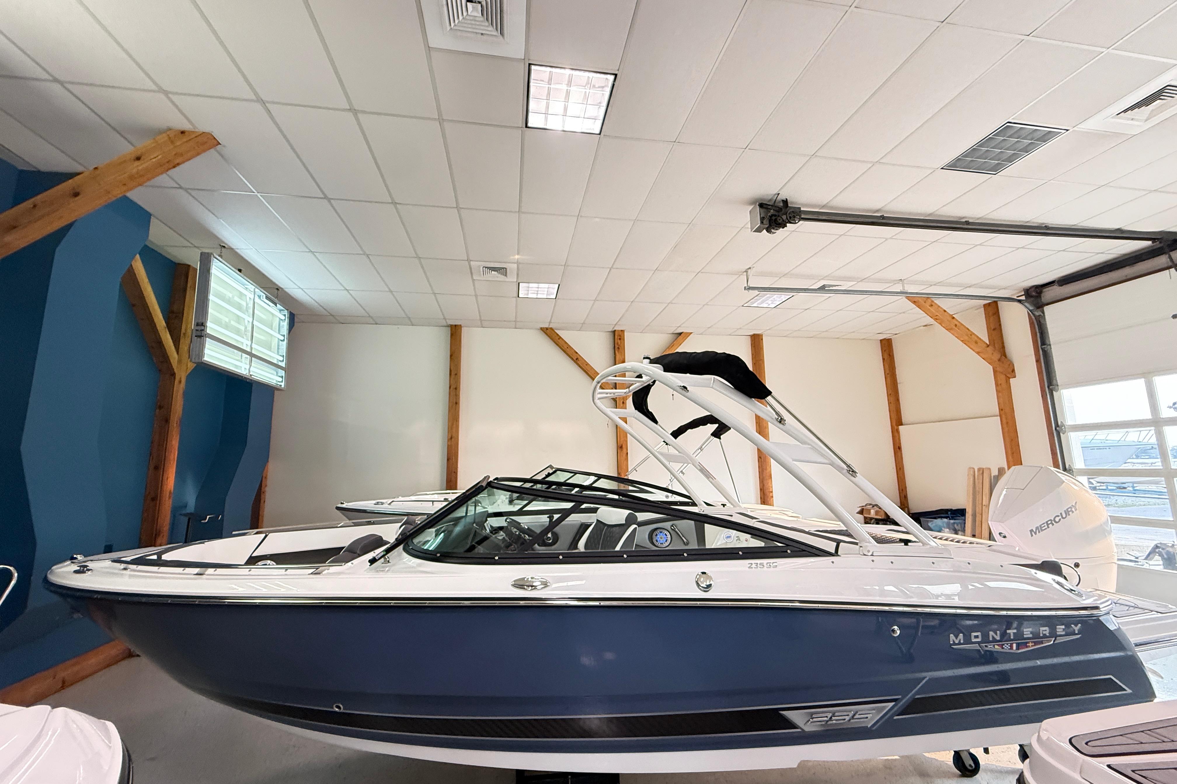 2025 Monterey 235SS Super Sport boat in showroom, featuring sleek design and modern features.